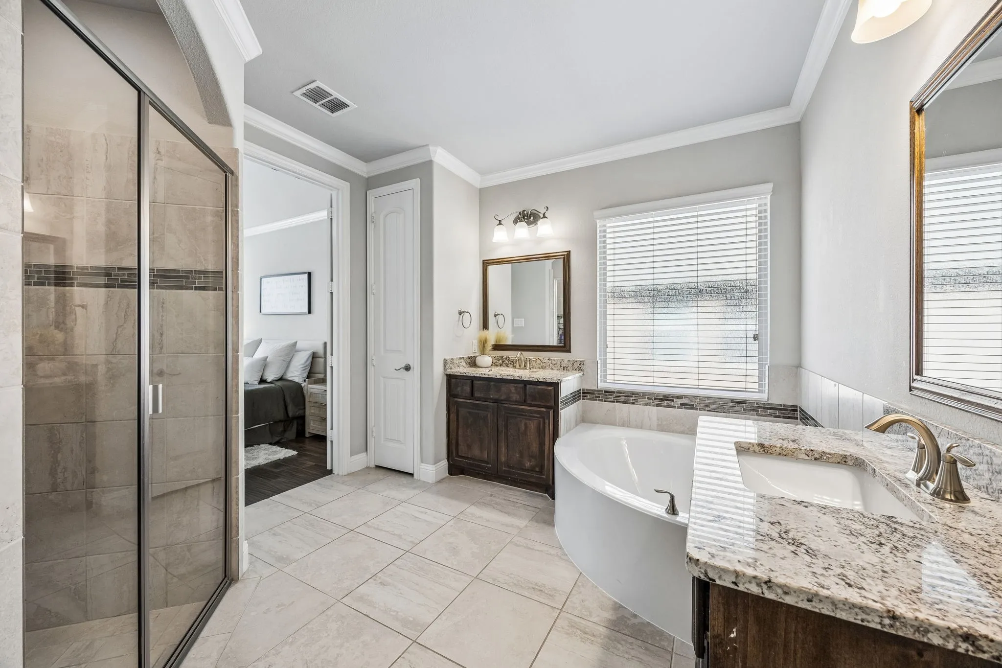 Dual vanities with tub and separate shower.