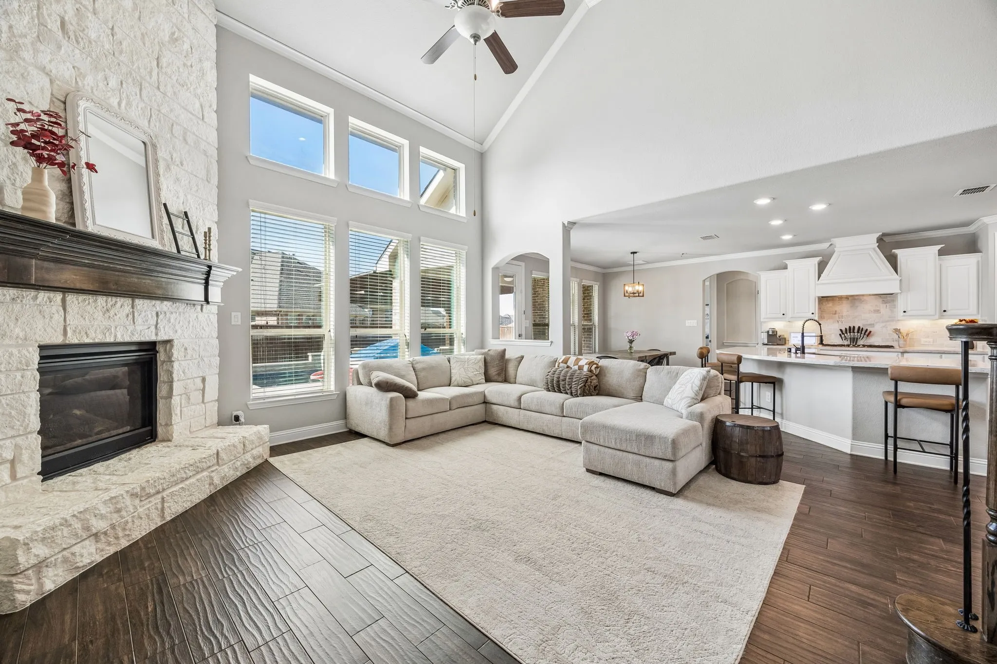 Family room open to the kitchen with floor to ceiling stone fireplace.