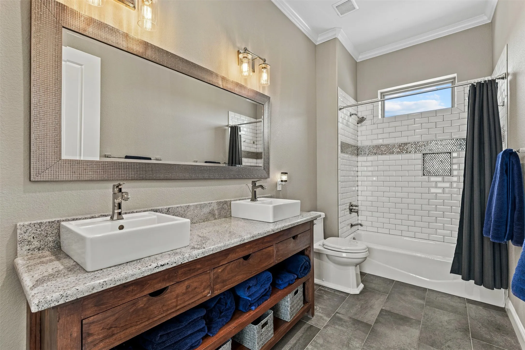 The guest bathroom is located between the two guest bedrooms and features dual sinks.