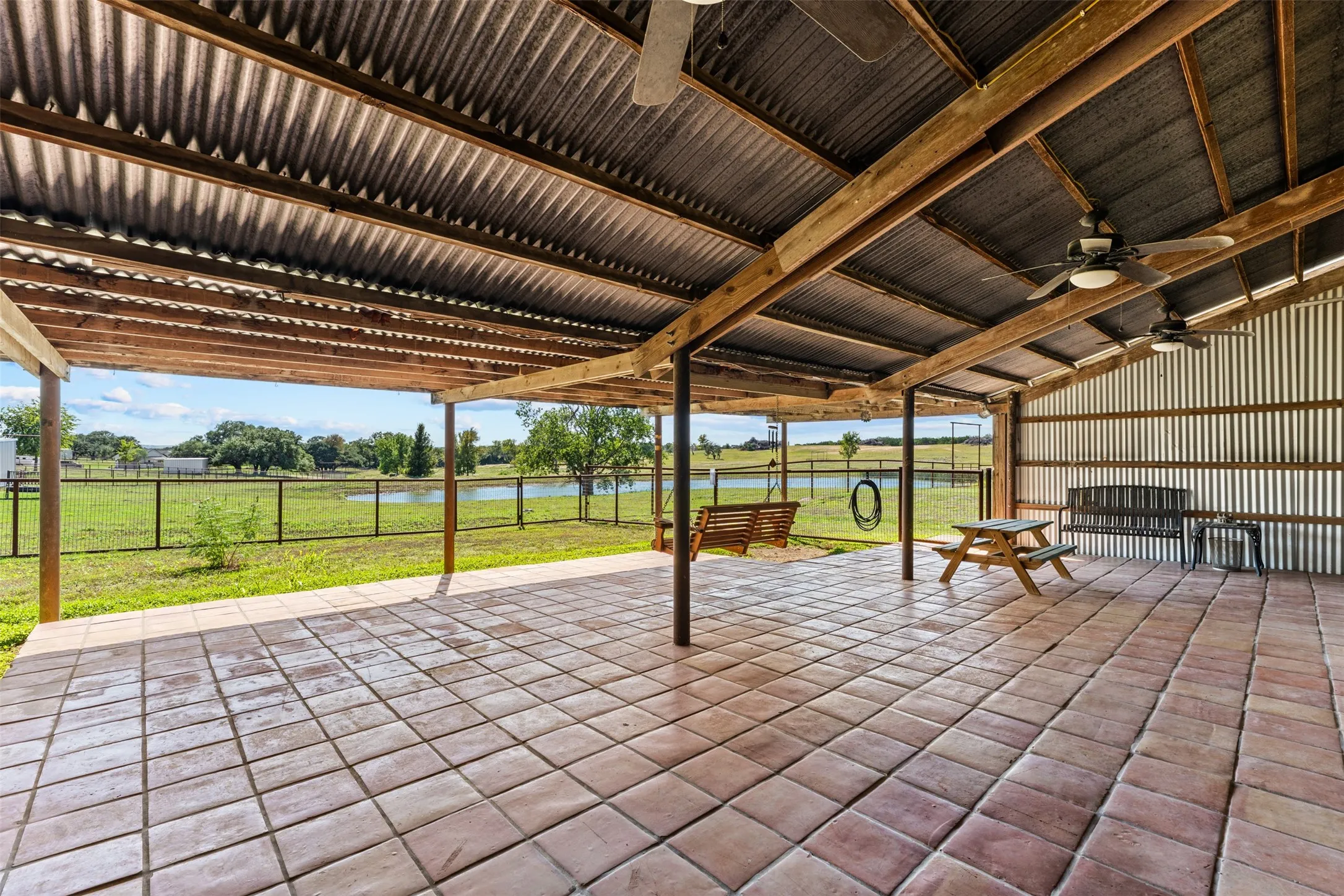 The back porch of the guest house overlooks the stocked tank.