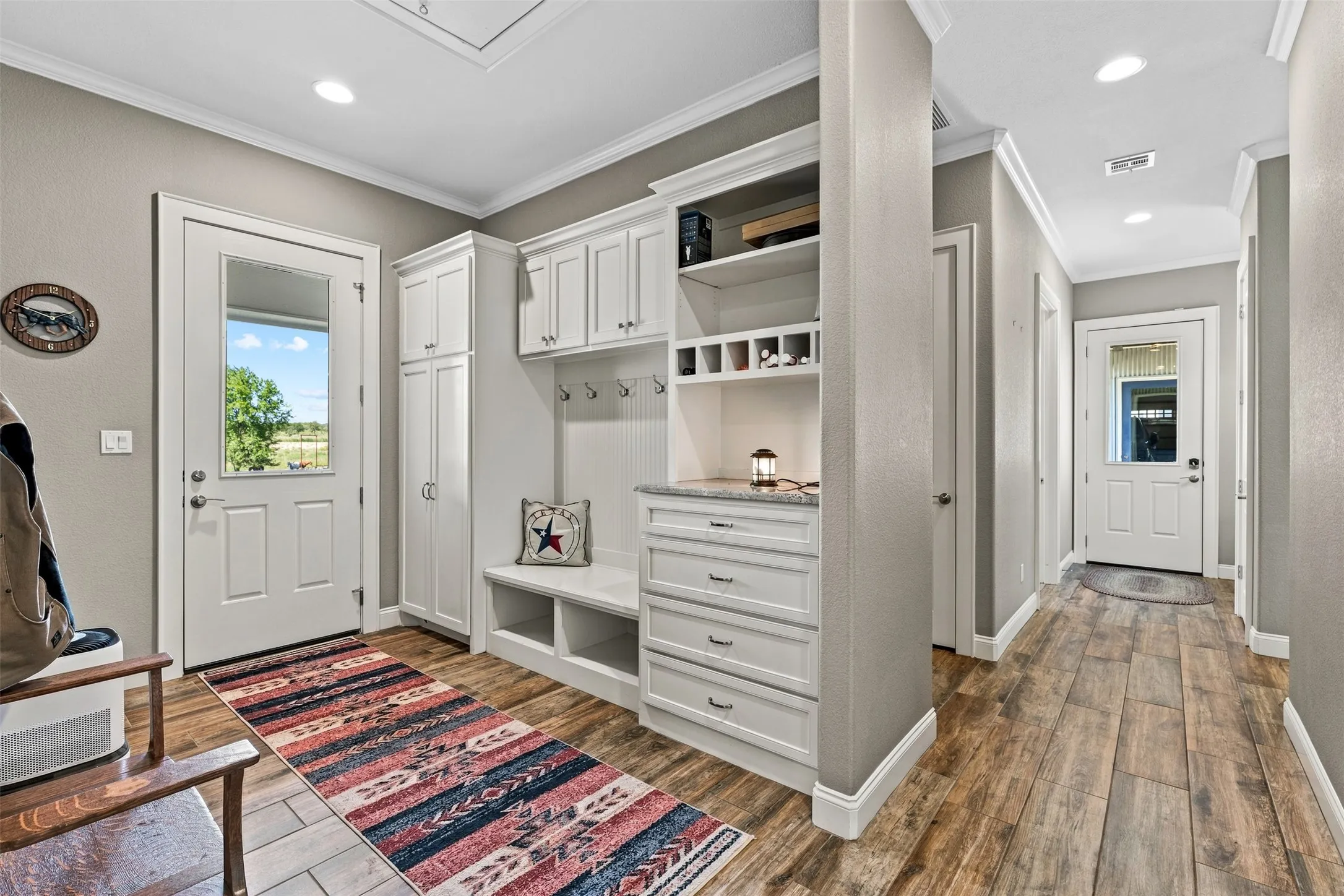 The mudroom is located just off of the kitchen and has seating, storage, and even places to plug in devices at the end of the day.