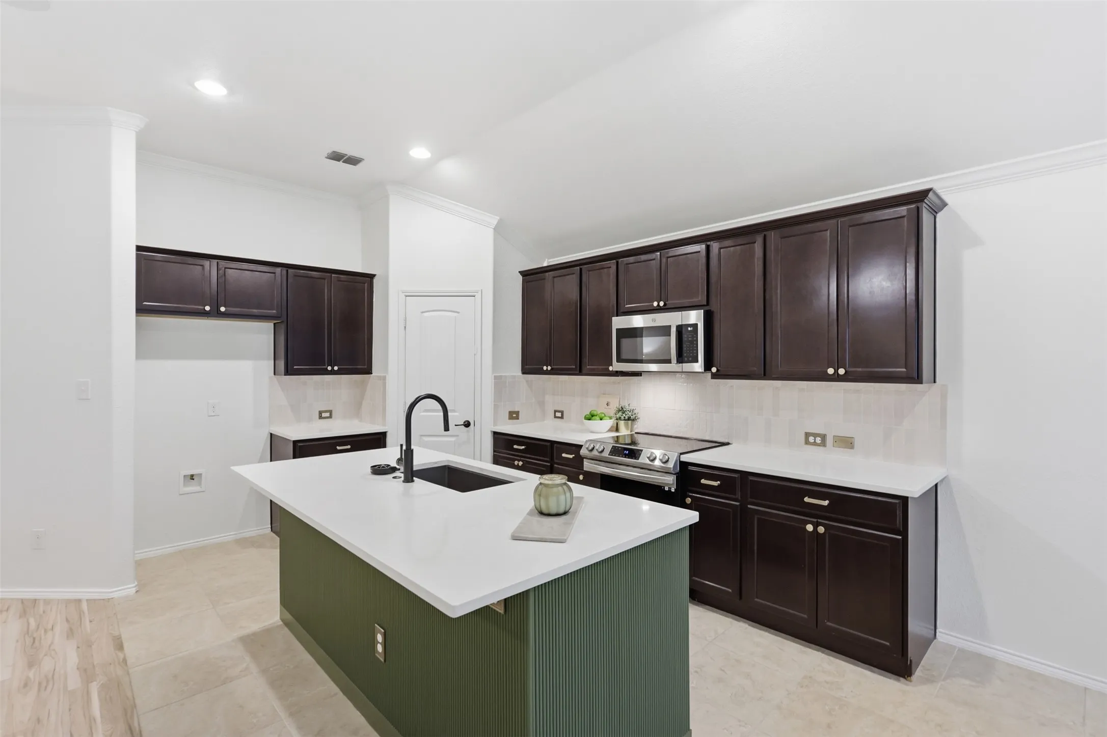 Updates include designer reeded detail and beautiful accent color on Kitchen island