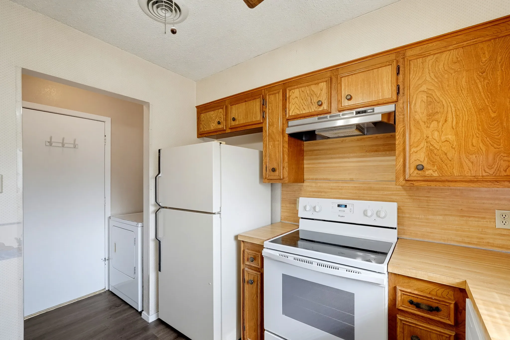 Cooking essentials sit side by side, with the laundry nook around the corner.