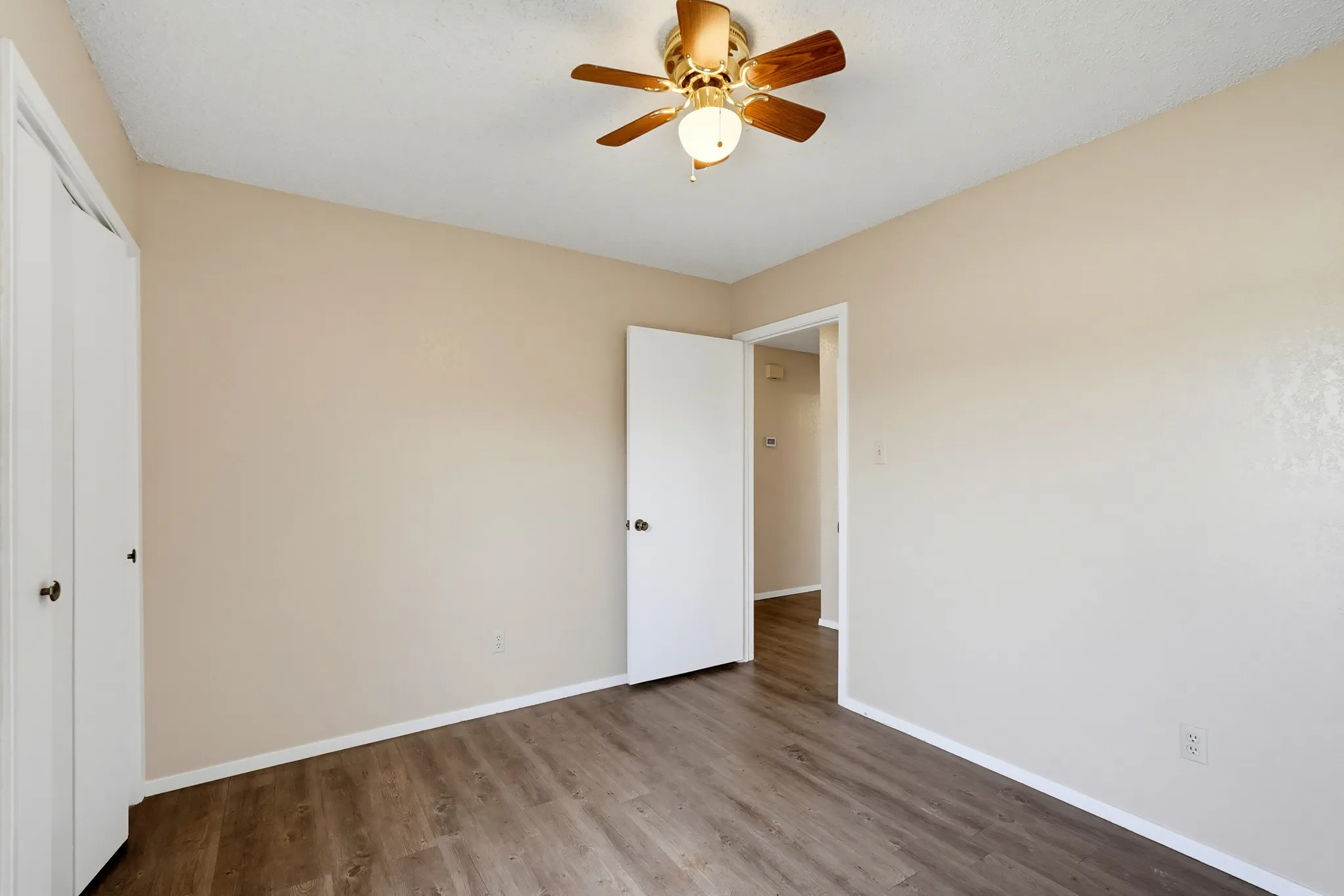 A short step from the hall, this private retreat keeps a closet tucked along one side.