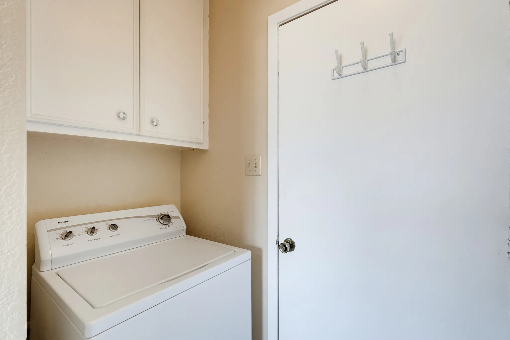 Laundry day gets a tidy corner, tucked out of sight.