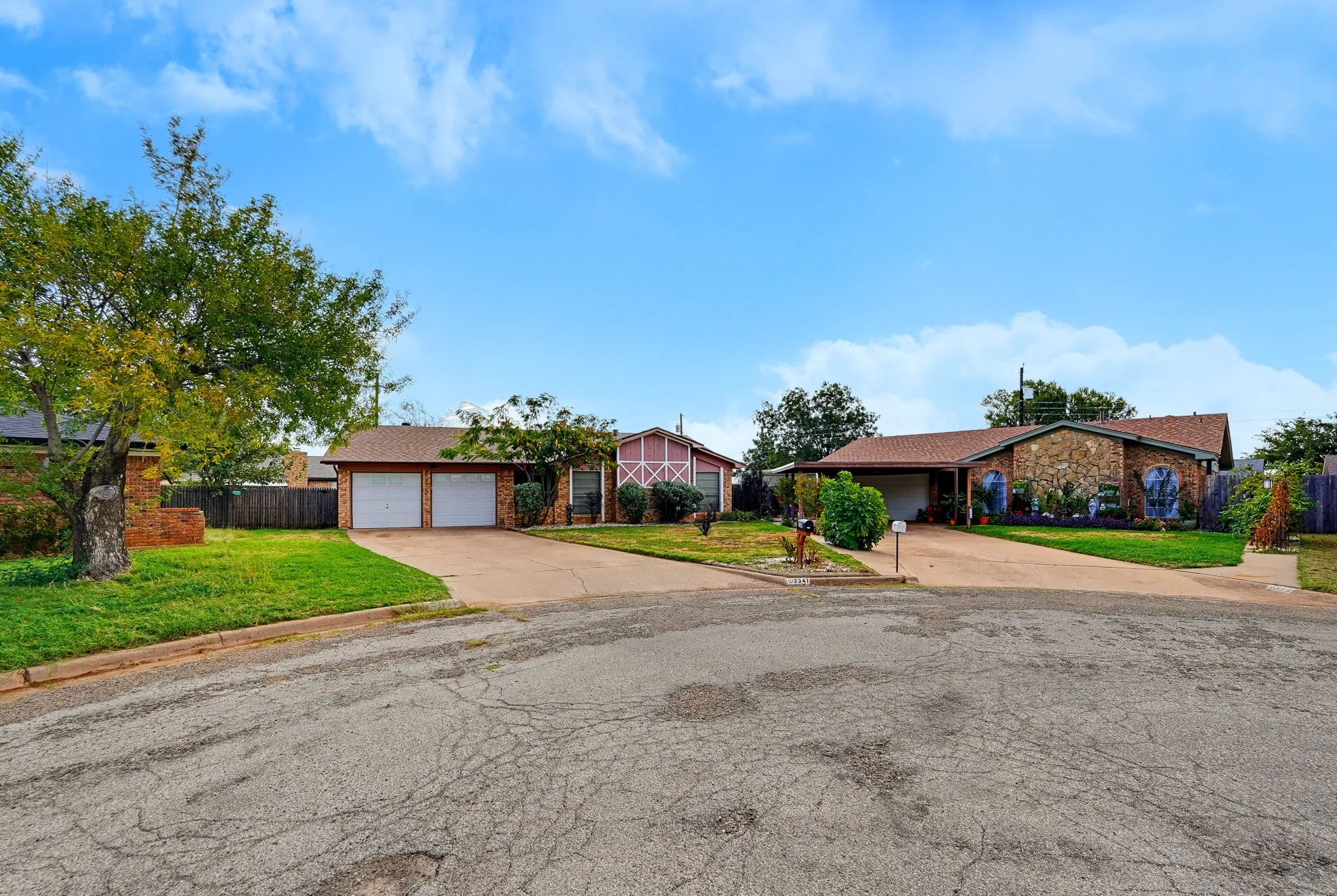 Settled at the bend of a quiet cul-de-sac, with a wide driveway and a two-car garage ready for guests.