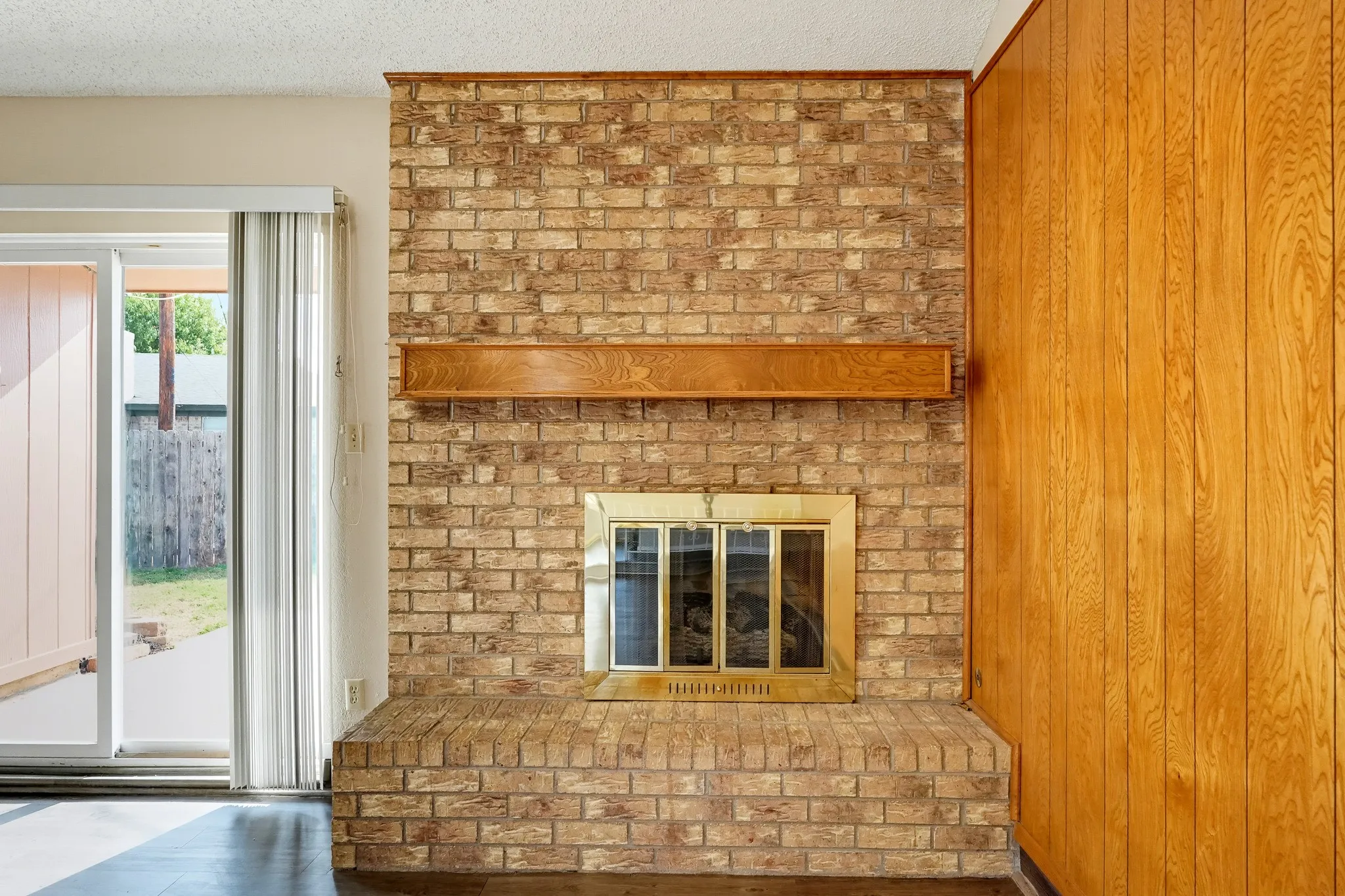 Brass-trimmed doors and a wood mantel, ready for sweater weather.