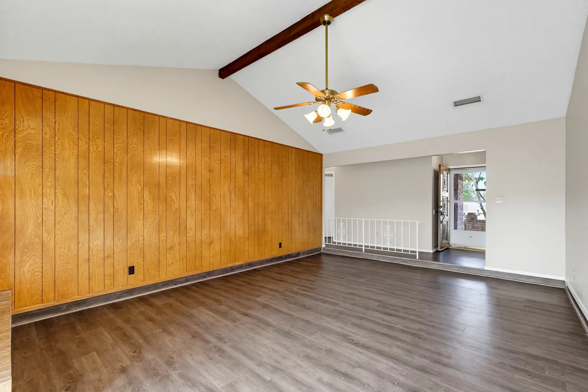 A gentle step-down and a wrought-iron rail add a dash of mid-century personality.