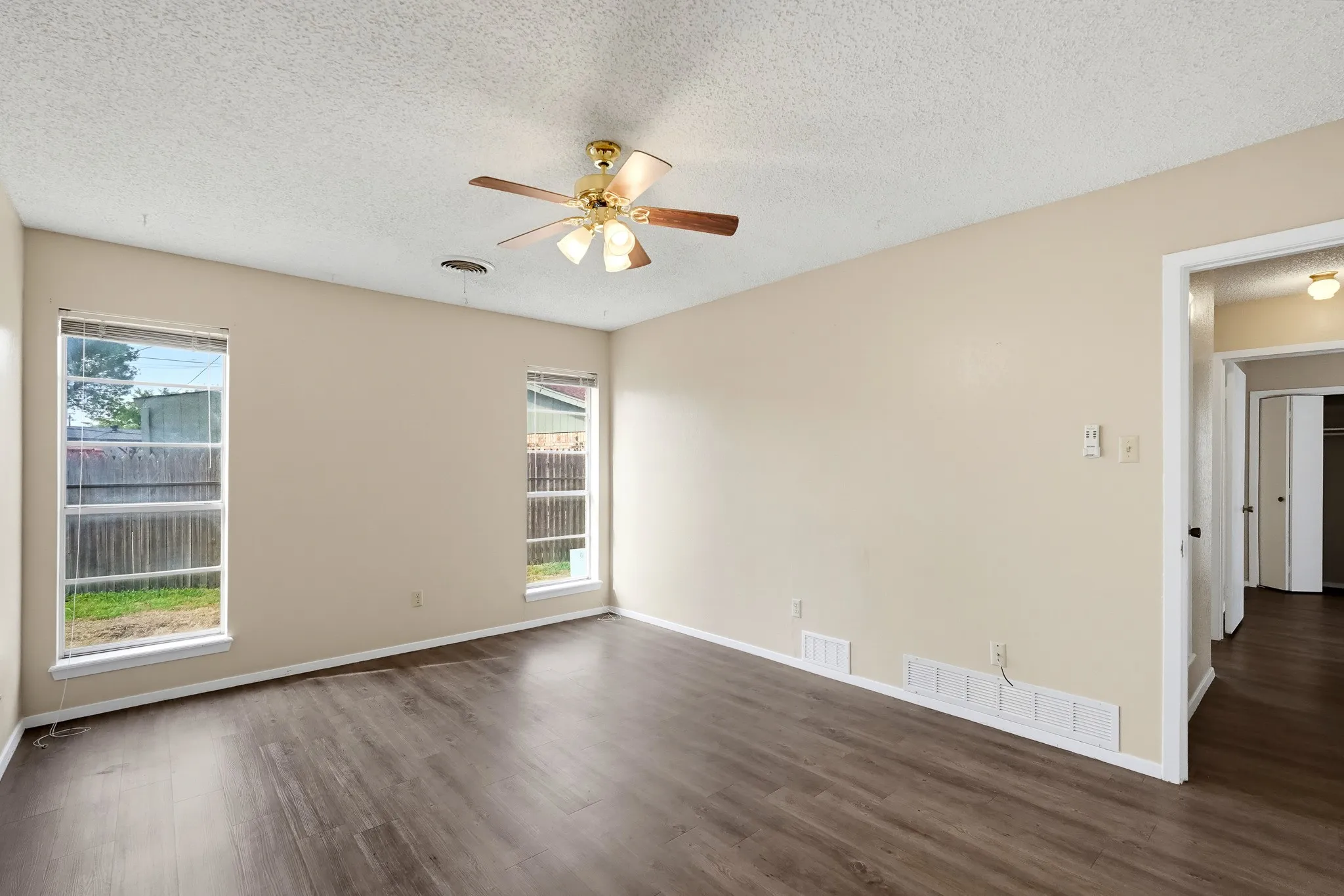 Twin windows peek out at the fenced lawn, ideal for slow weekend coffee.