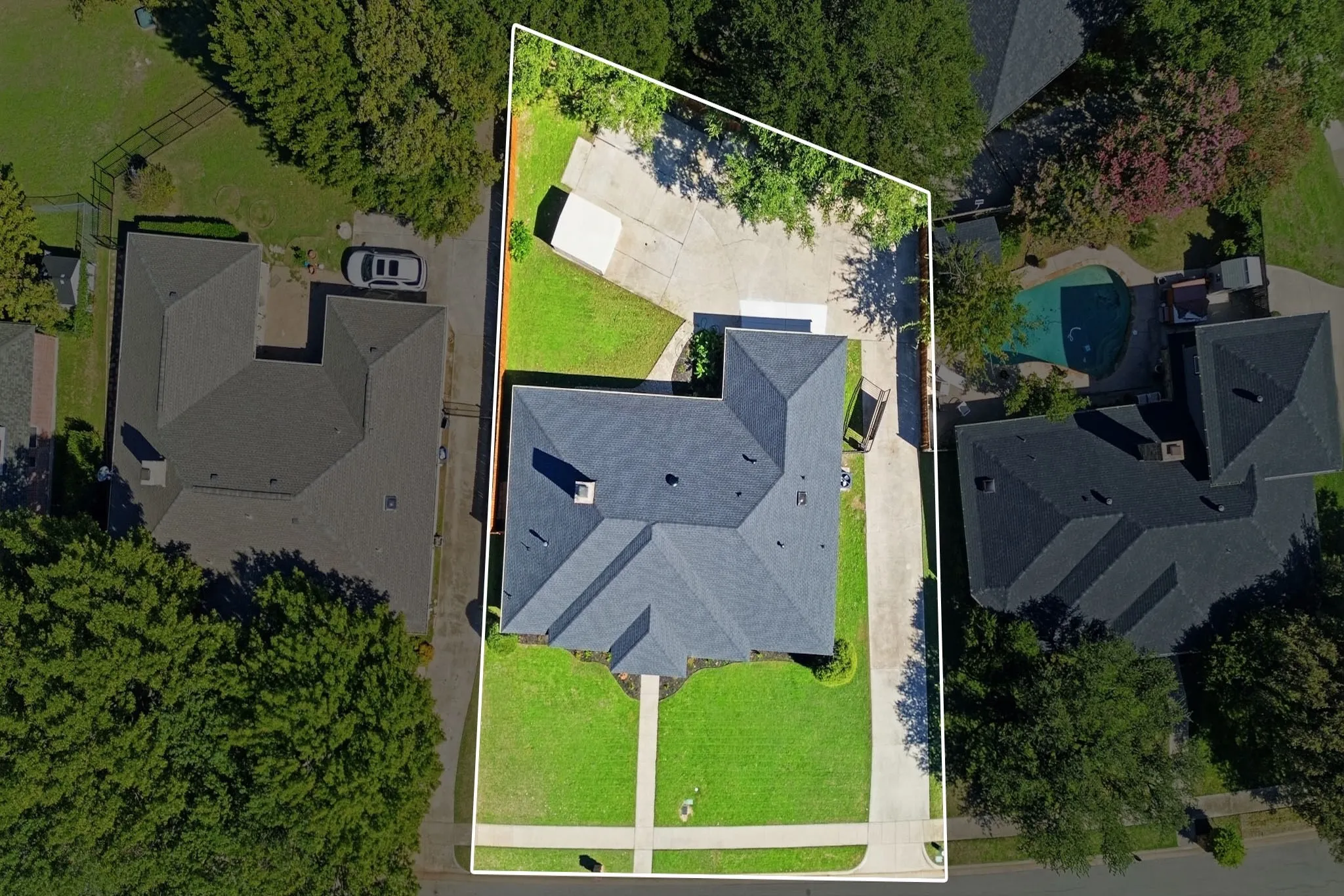 Aerial perspective featuring a multi-pitched shingled roof, concrete driveway, detached storage structure, and fenced grounds