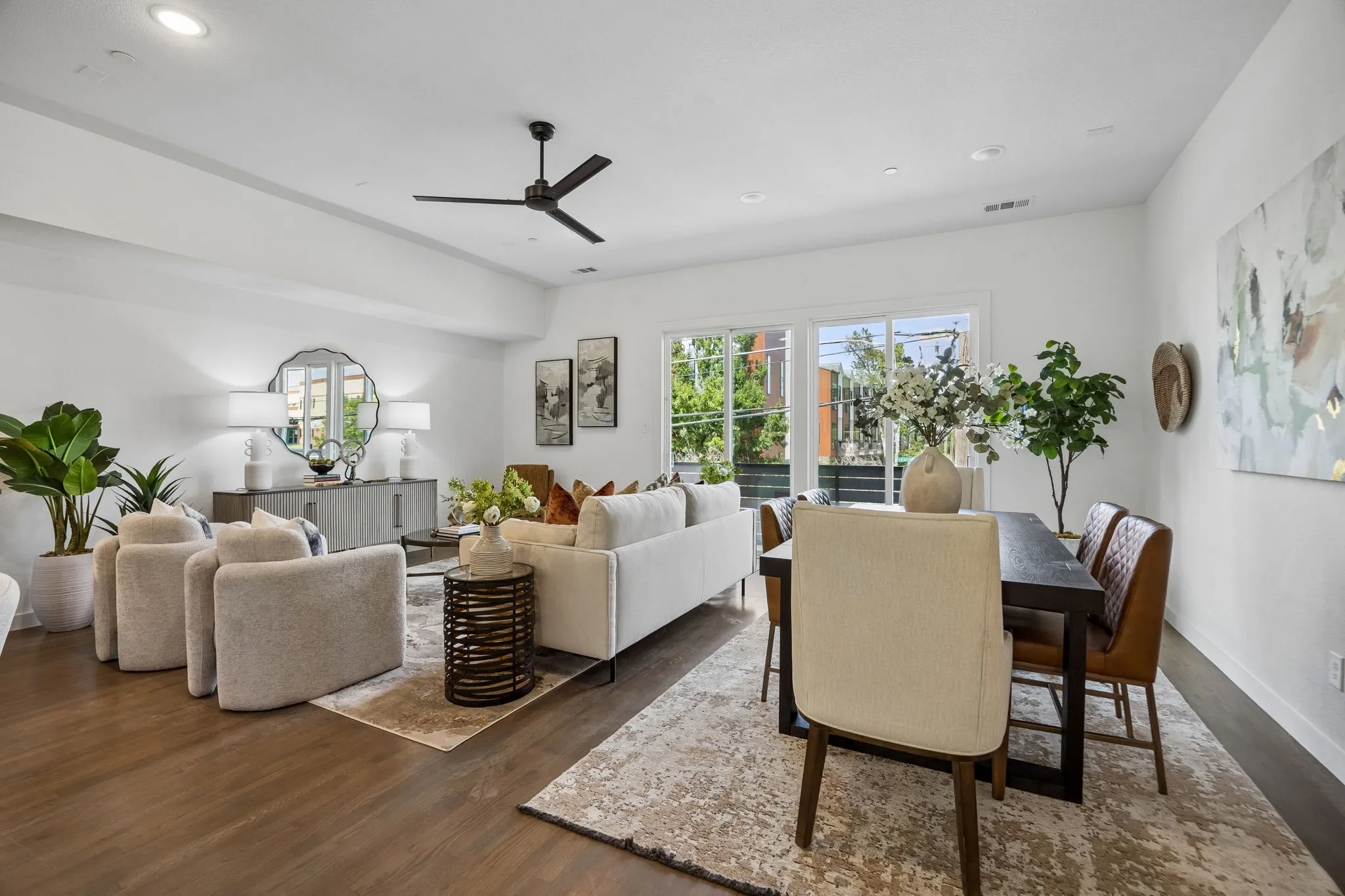Open-concept interior featuring wood-finish flooring, recessed lighting, a modern ceiling fan, and sliding glass doors