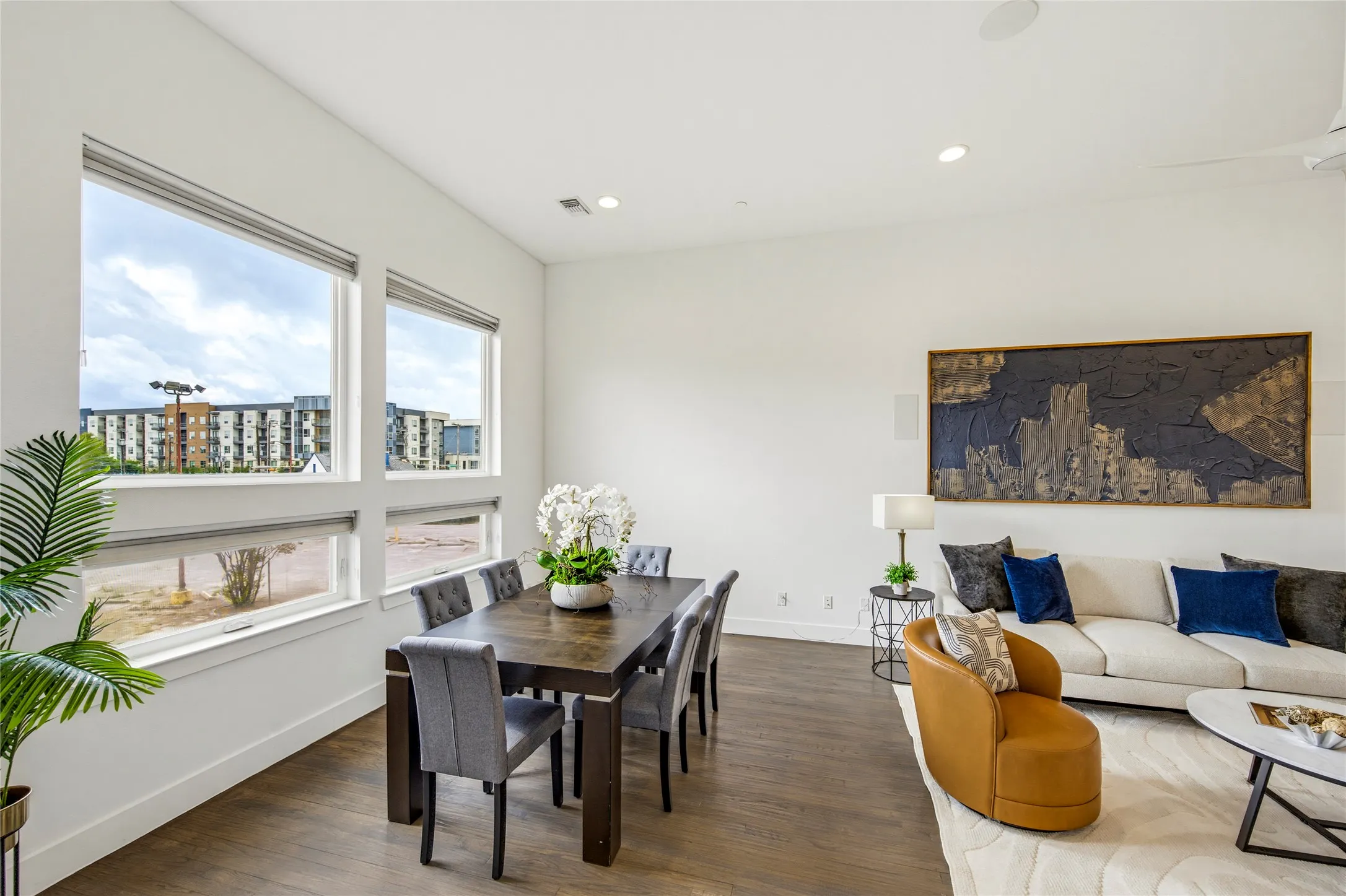 High ceilings, wood-finish flooring, expansive windows, and recessed lighting