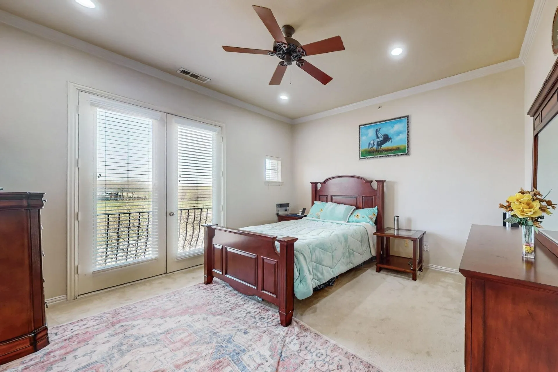 Double glass-pane doors with integrated blinds, crown molding, recessed lighting, and a ceiling fan