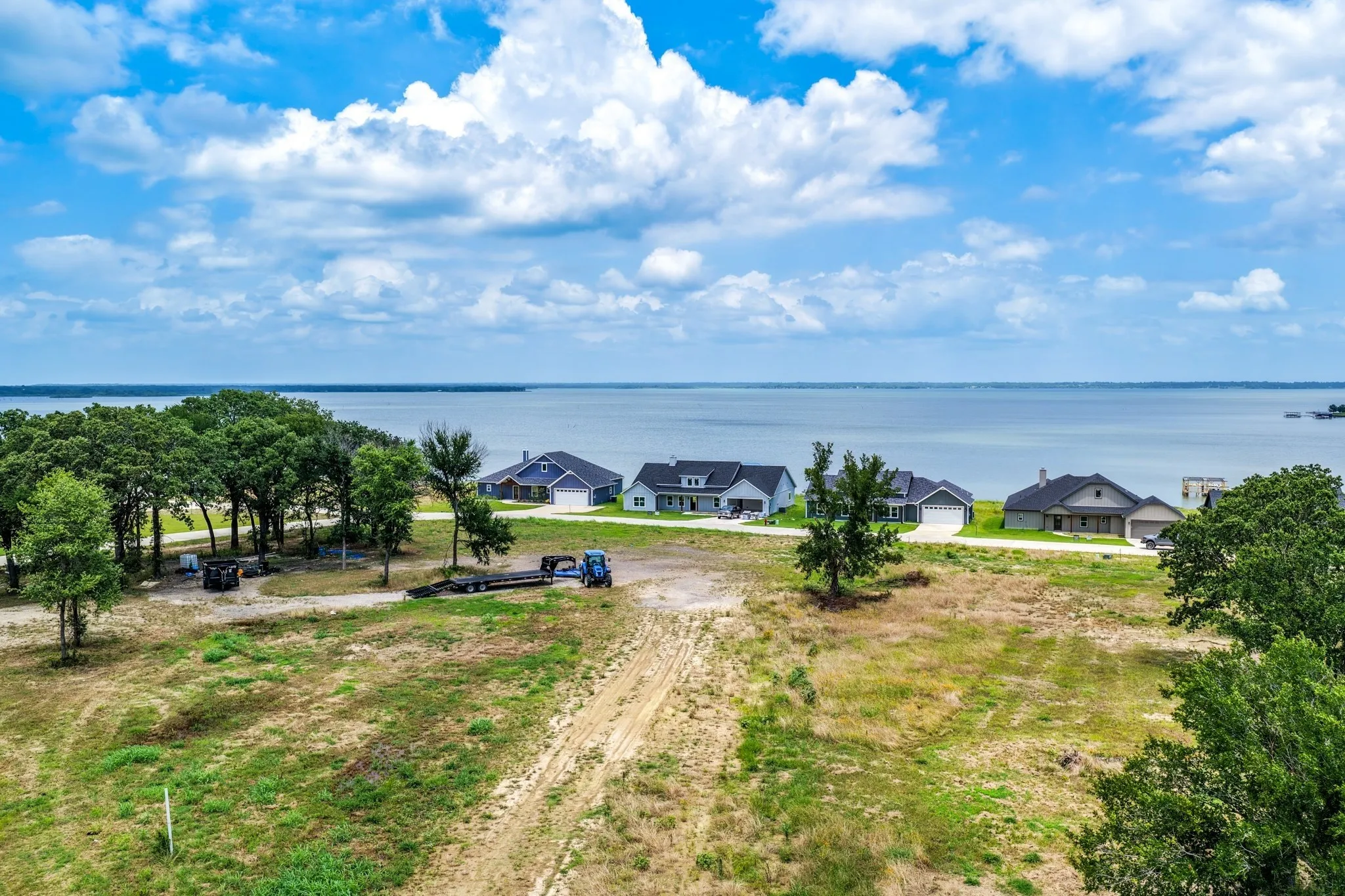 Expansive waterfront parcel featuring mature trees, native vegetation, and direct shoreline frontage