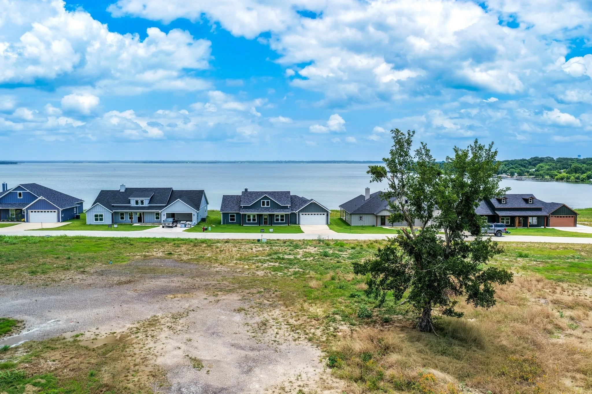 Expansive residential lot featuring waterfront placement with clear shoreline frontage and mature tree growth