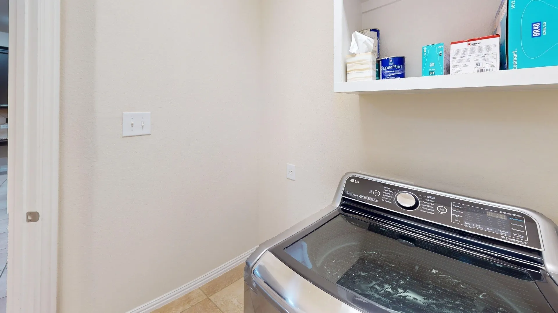 Built-in overhead shelving with white cabinetry finish and tile flooring