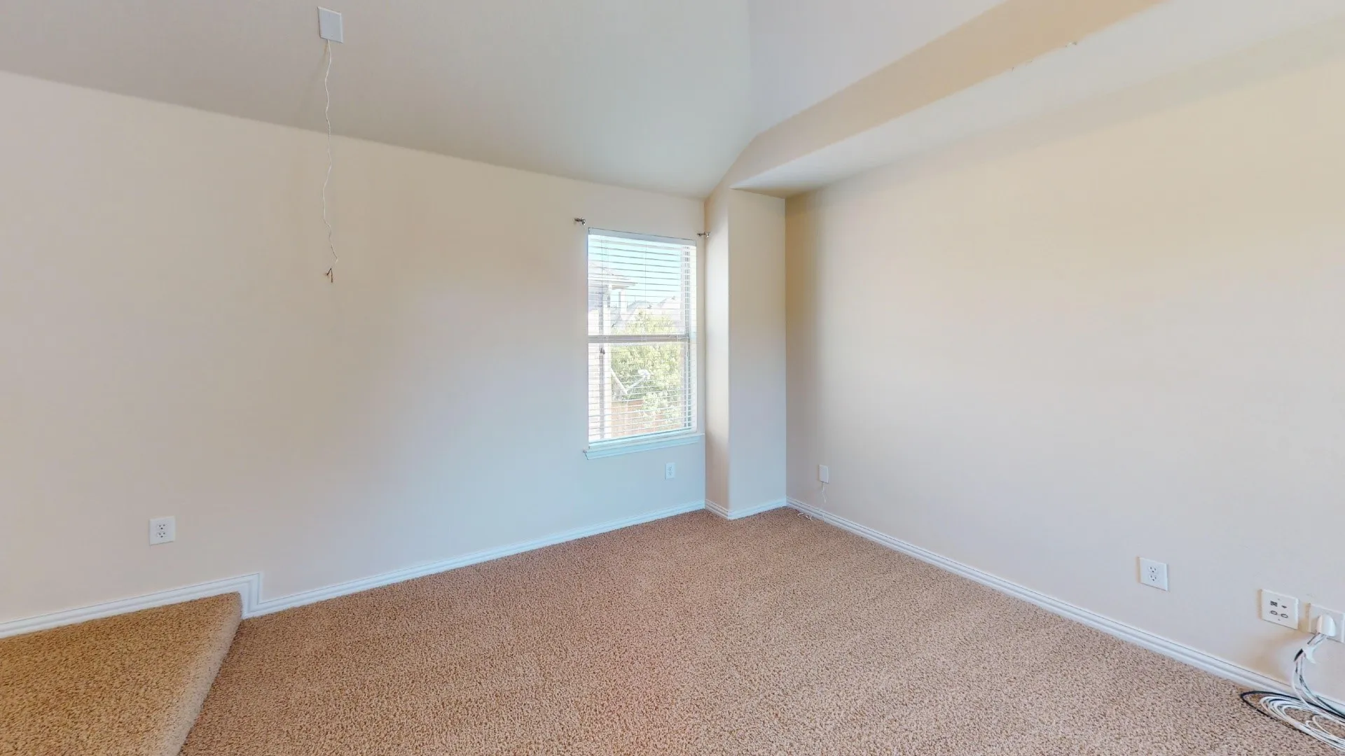 Vaulted ceilings featuring neutral wall paint, carpeted flooring, and a window with blinds