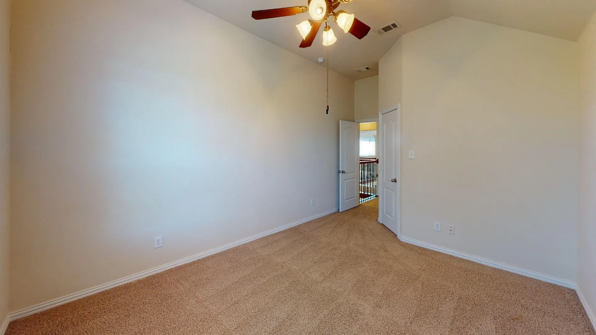 Room featuring a vaulted ceiling, neutral wall tones, wall-to-wall carpeting, and a multi-light ceiling fan