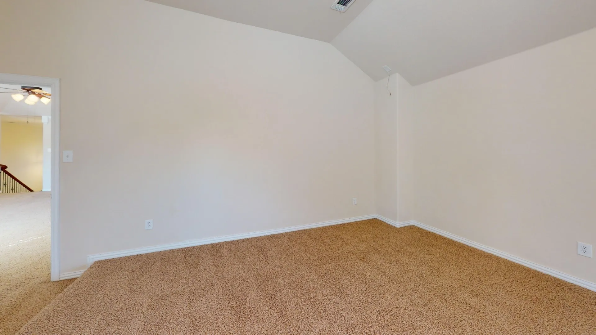Interior space featuring vaulted ceilings and neutral wall-to-wall carpeting