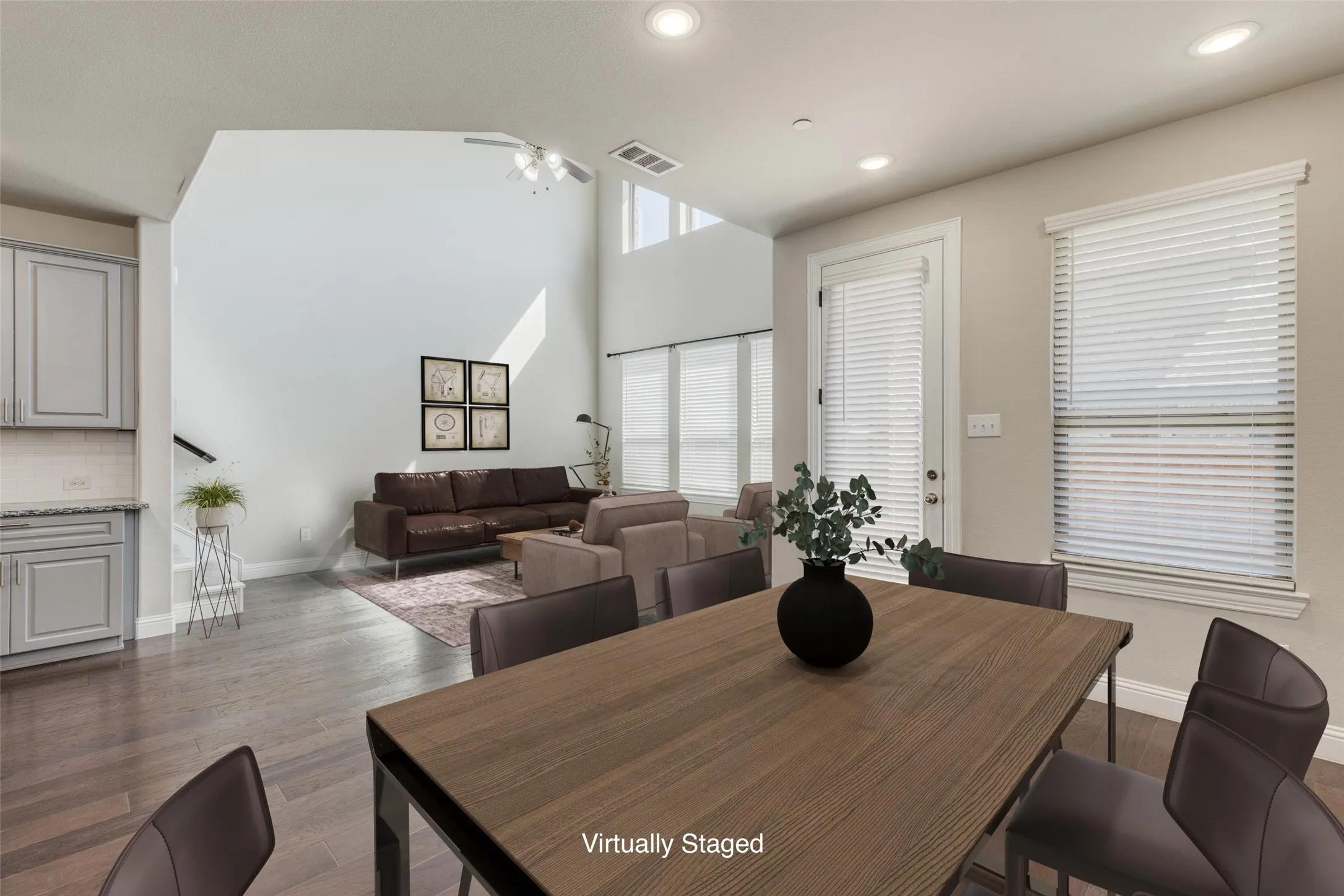 Virtually Staged to show the flow from Dining Room to Living Space