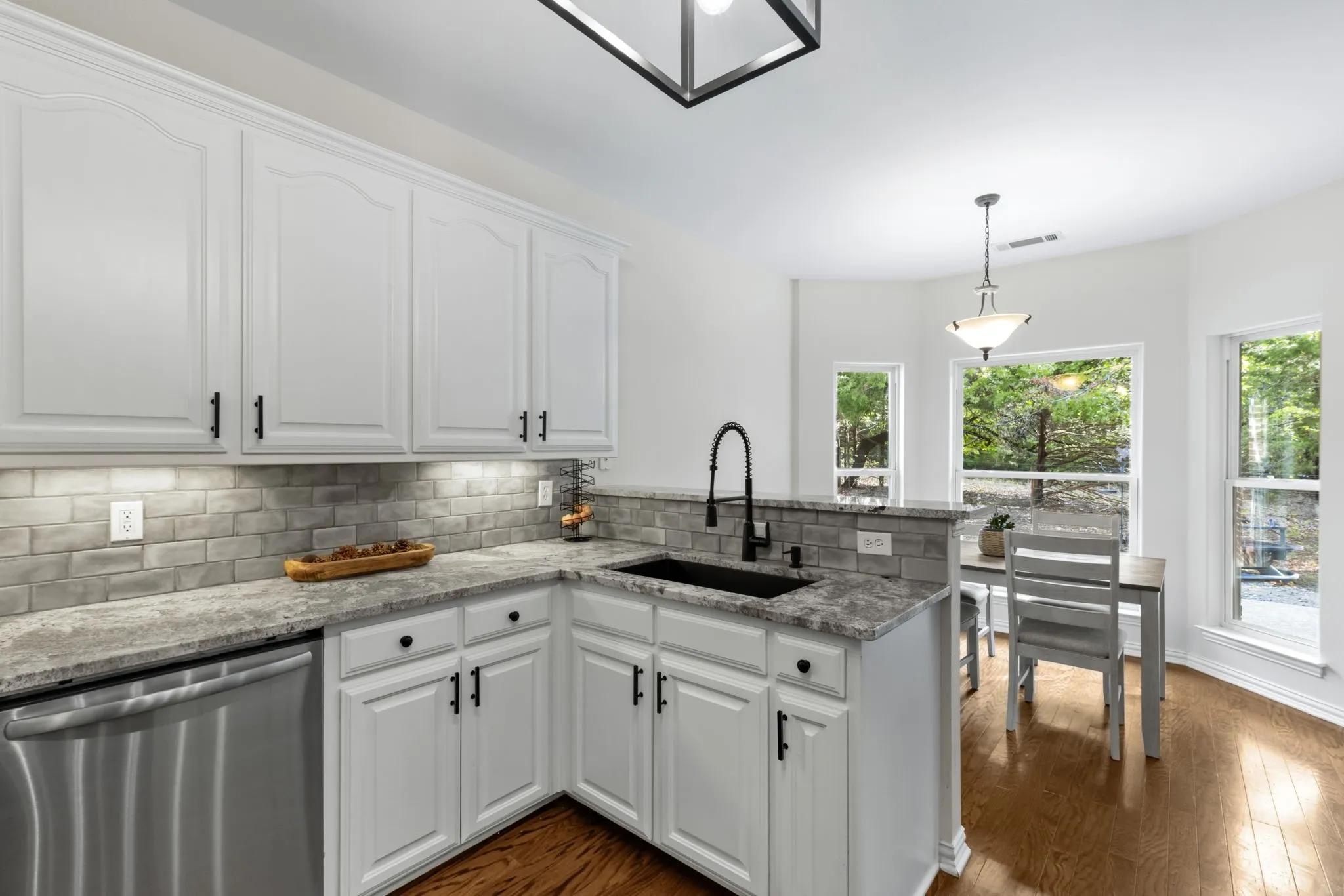 The kitchen and breakfast areas with backyard view.
