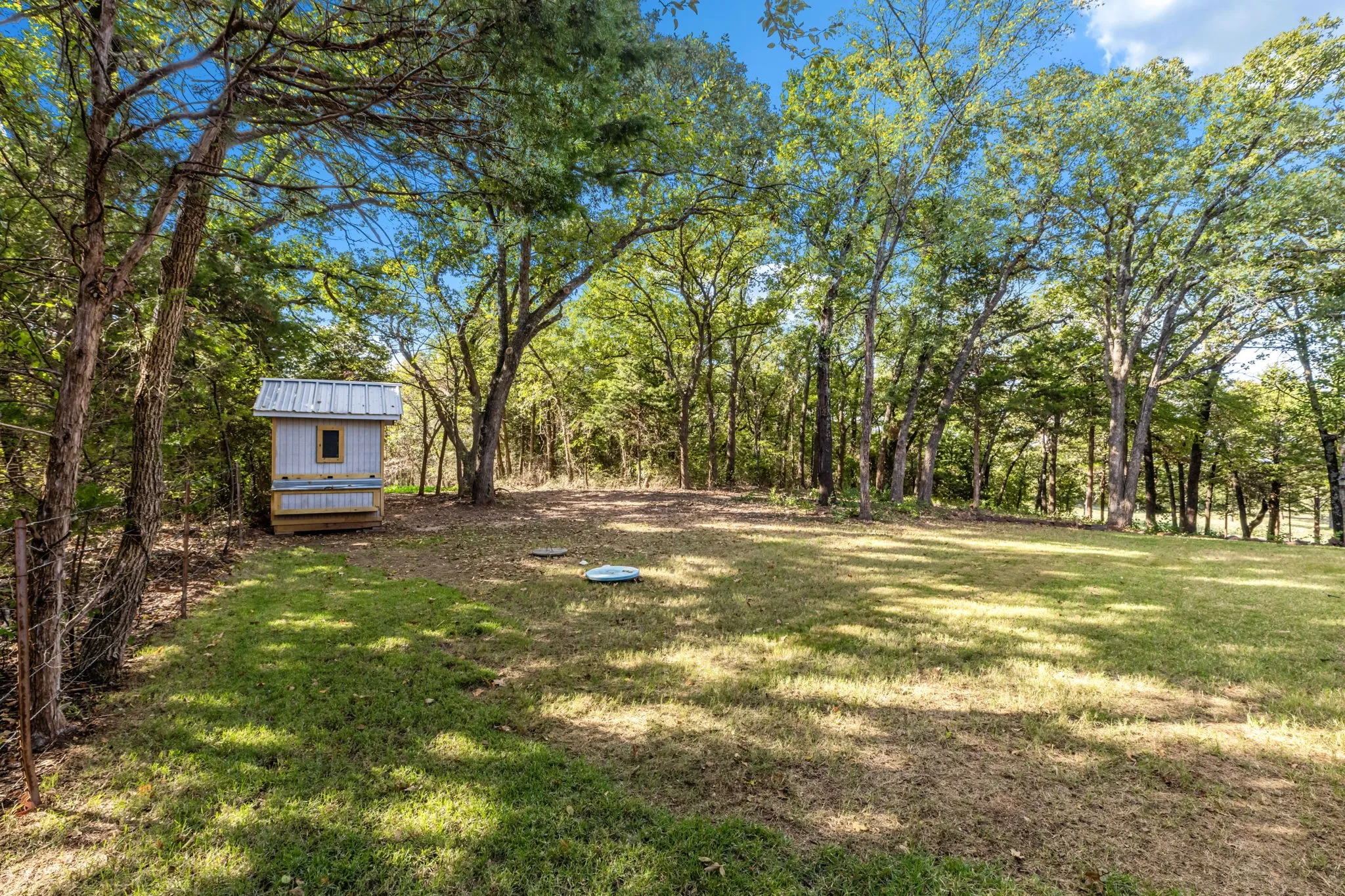 A cleared grassy area offers plenty of room for play, pets & outdoor activities.