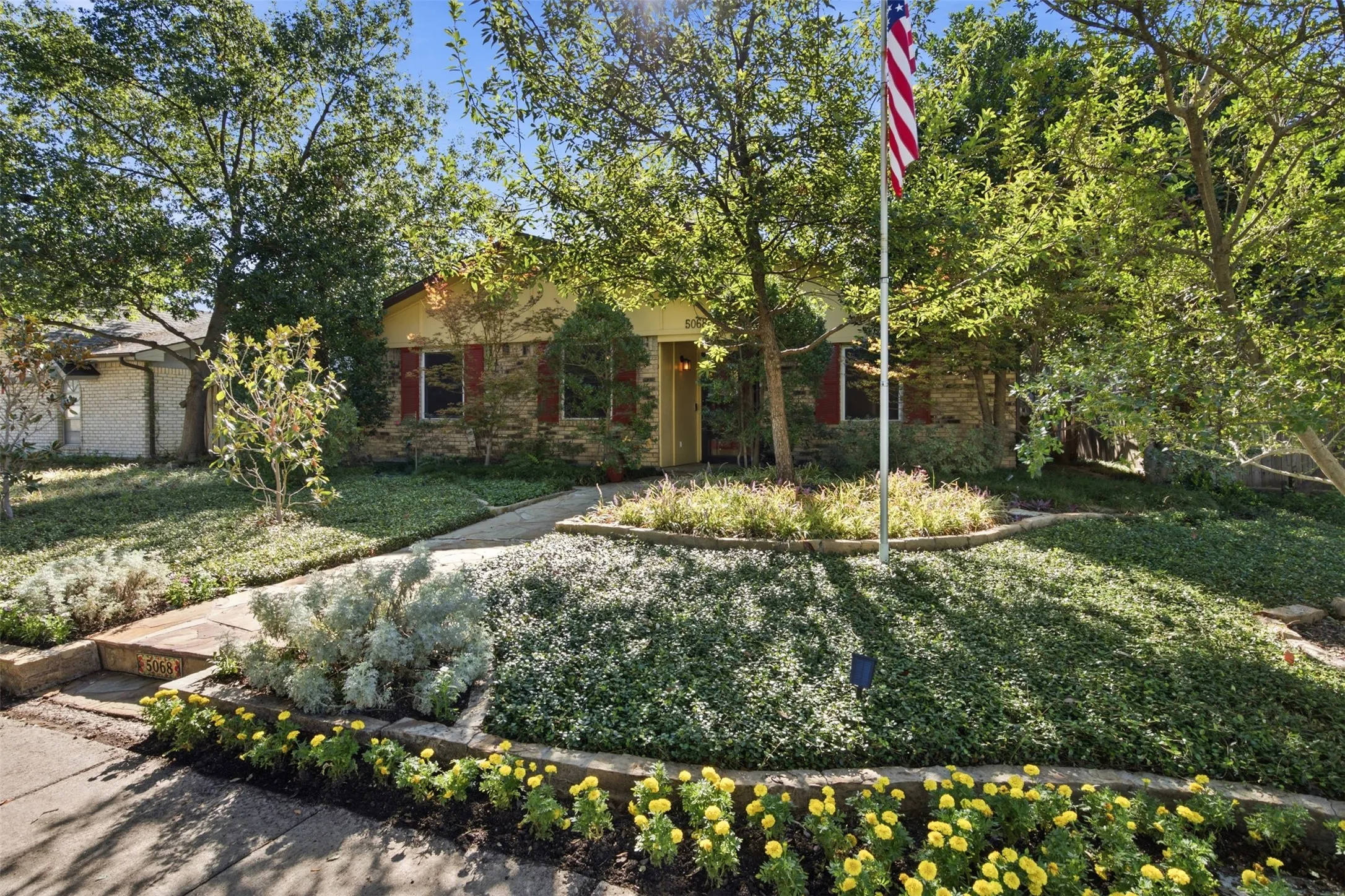Exterior facade featuring stone accents and red shutters