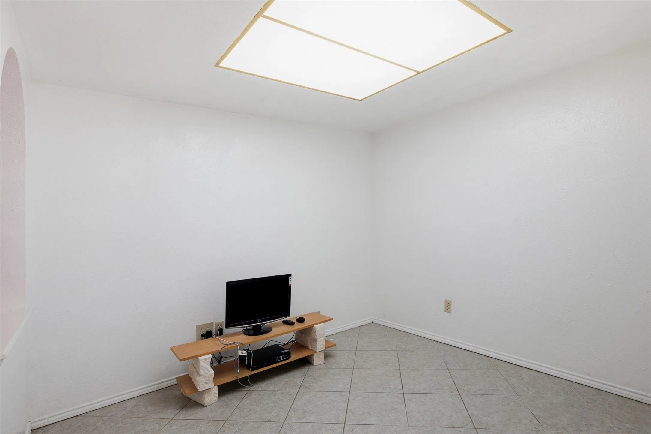 Recessed ceiling lighting, tiled flooring, and light-colored walls