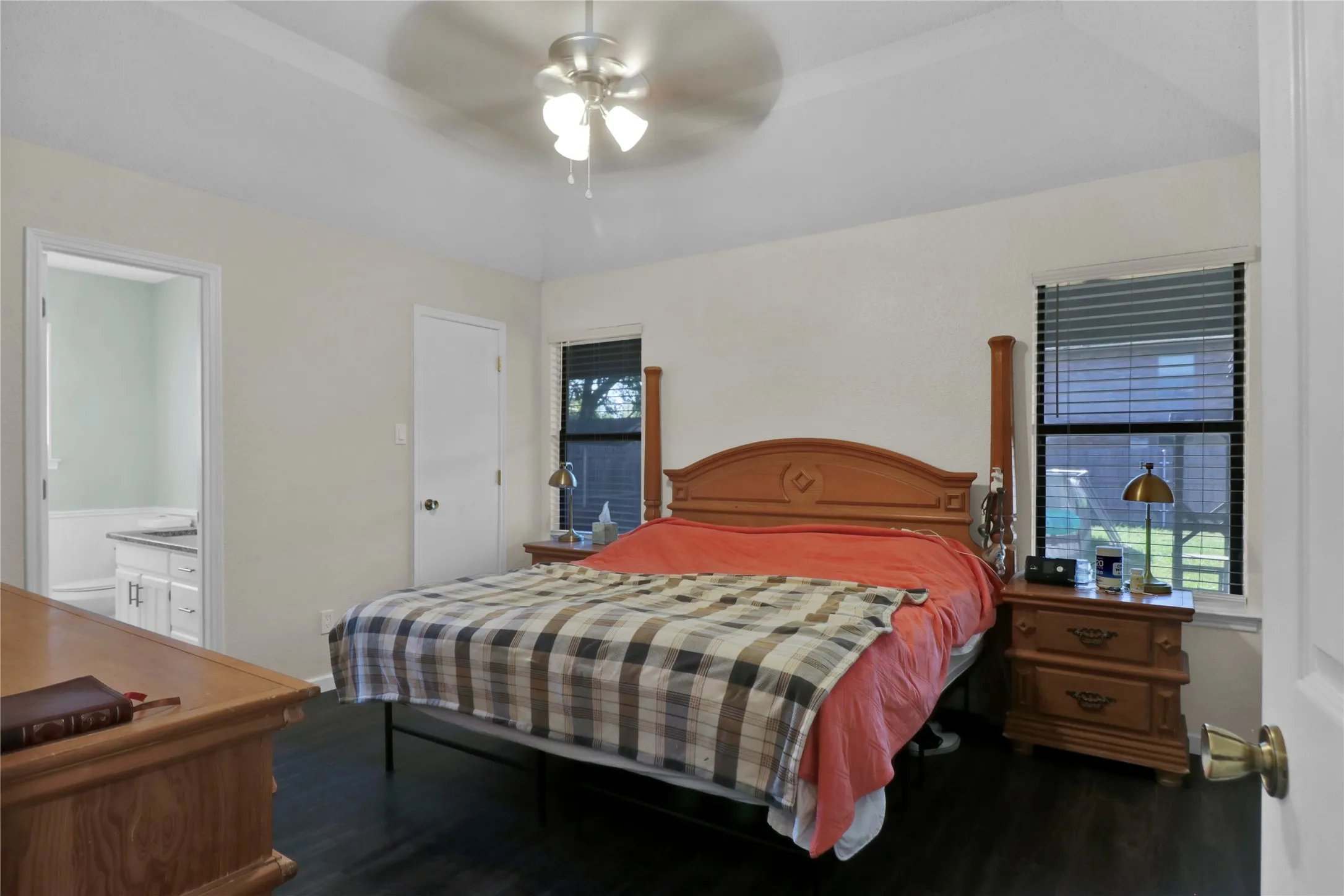 Master suite with windows overlooking backyard.