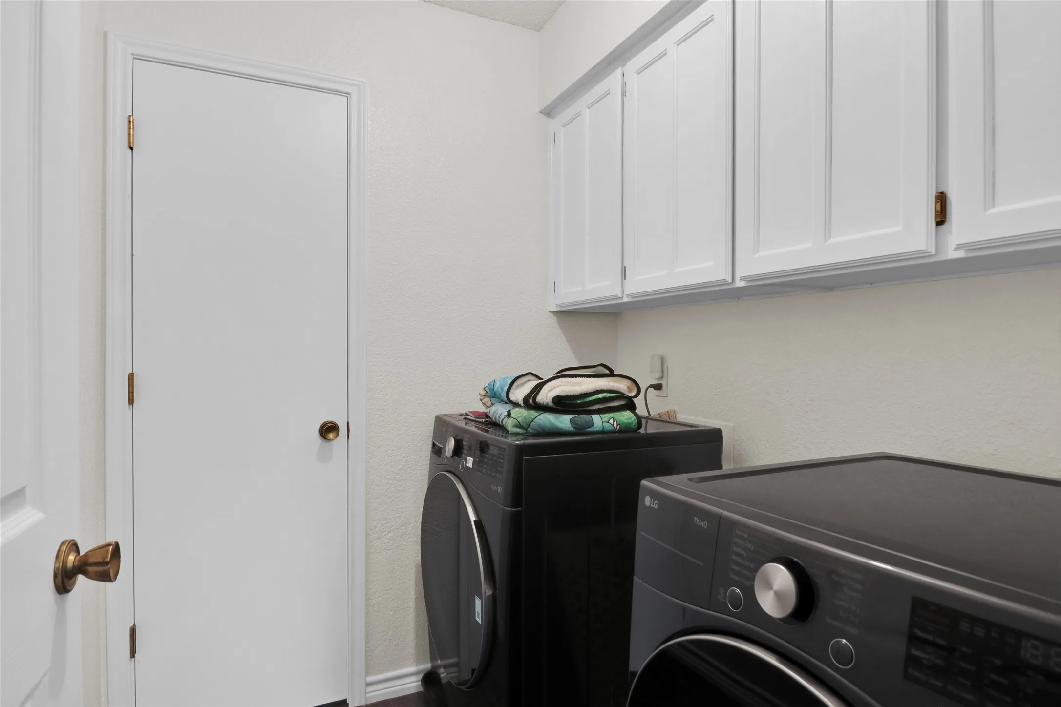 Laundry room with built in cabinets.