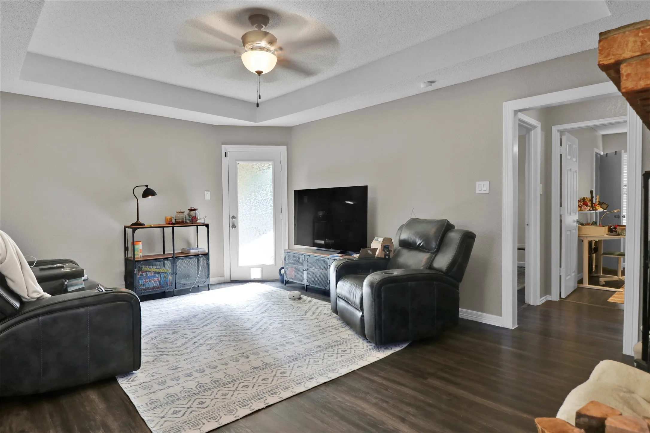 Living room. To right is secondary bedrooms and bath. Door straight ahead leads to backyard.