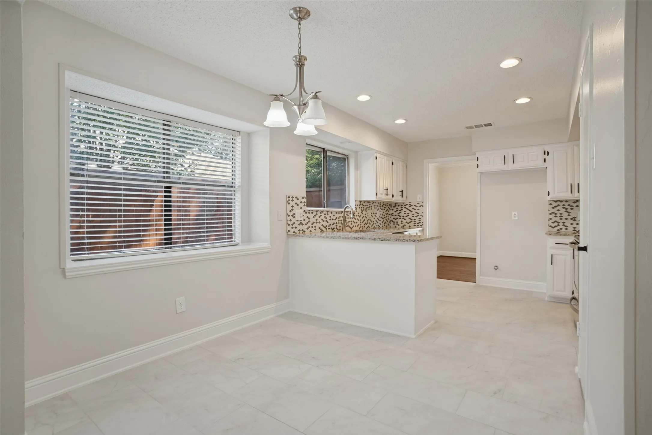 Breakfast area and kitchen, new porcelain tile floors.