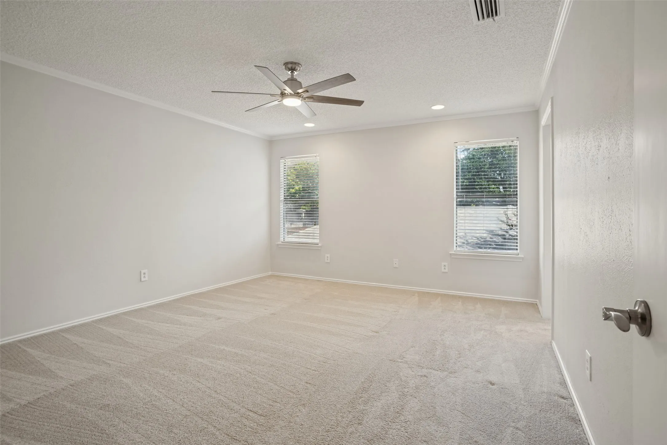 Primary bedroom with ensuite bath and two walk-in closets.