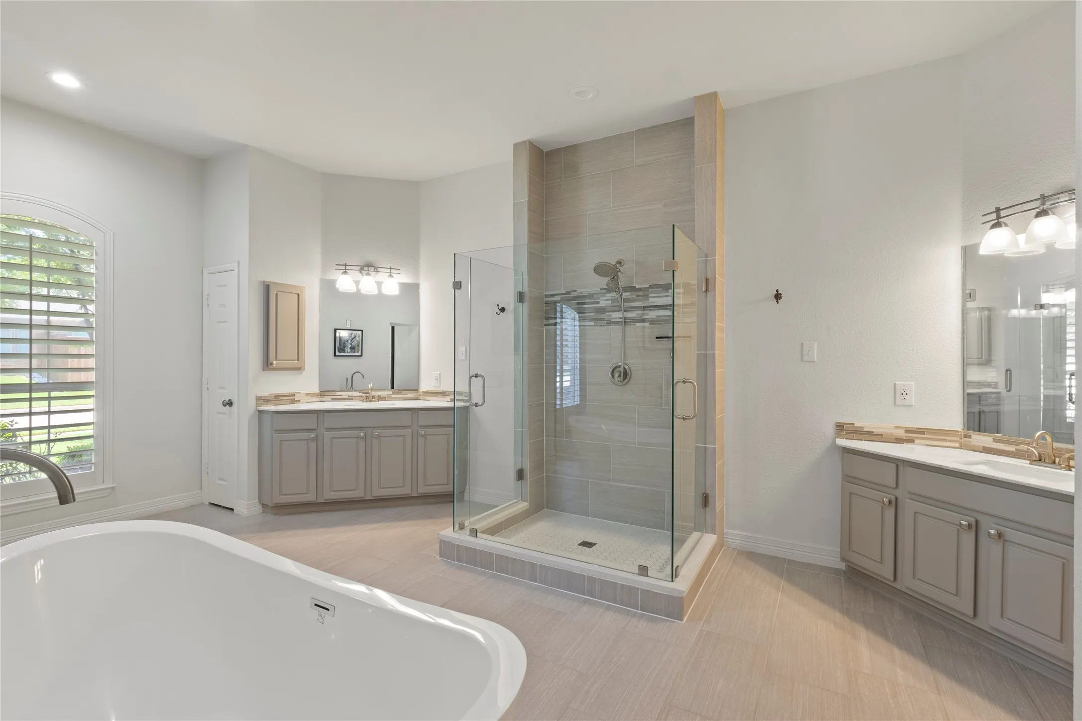 New frameless shower, soaking tub, separate sinks