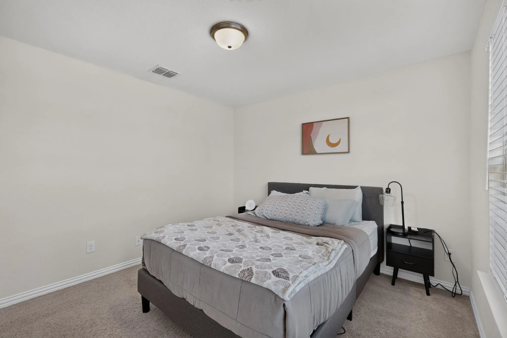 Neutral interior space featuring wall-to-wall carpeting and a flush-mount ceiling light fixture
