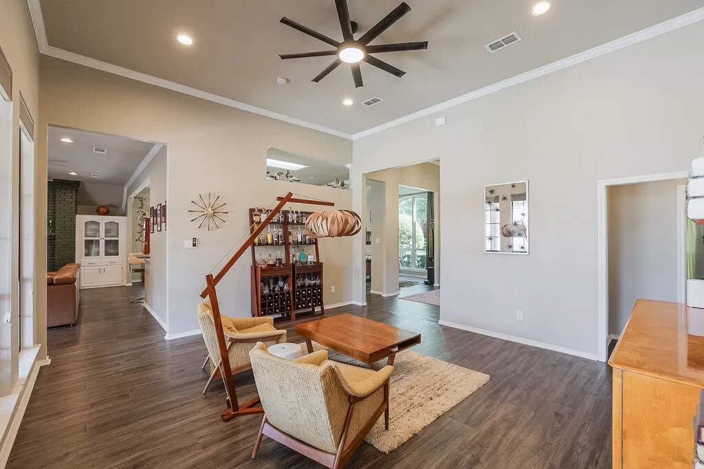 High ceilings featuring a multi-blade ceiling fan, recessed lighting, and wood-finish flooring