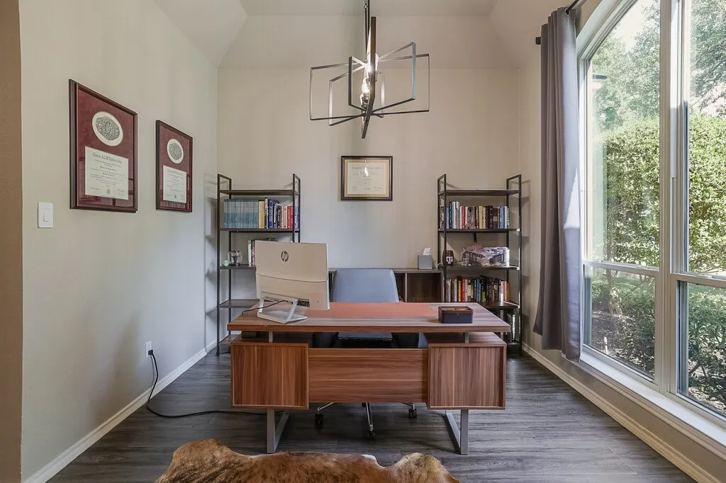 Vaulted ceiling featuring a geometric metal chandelier, wood-finish flooring, and expansive floor-to-ceiling windows