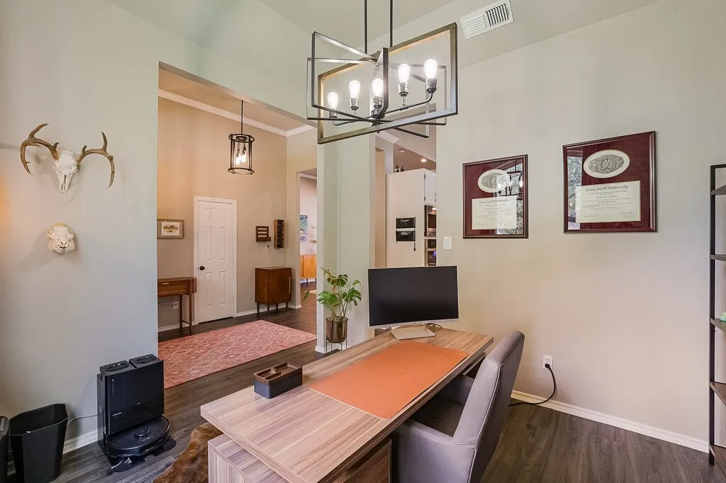 Vaulted ceilings, wood-finish flooring, geometric-frame chandelier, and inset lighting
