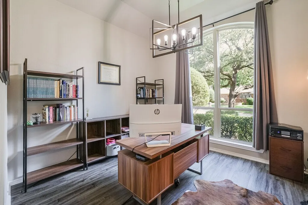 Vaulted ceiling, arched floor-to-ceiling window, wood-finish flooring, and geometric chandelier