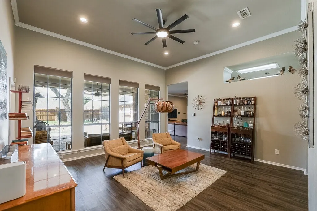 High ceilings with recessed lighting, wood-finish flooring, multi-pane windows, and an oversized ceiling fan