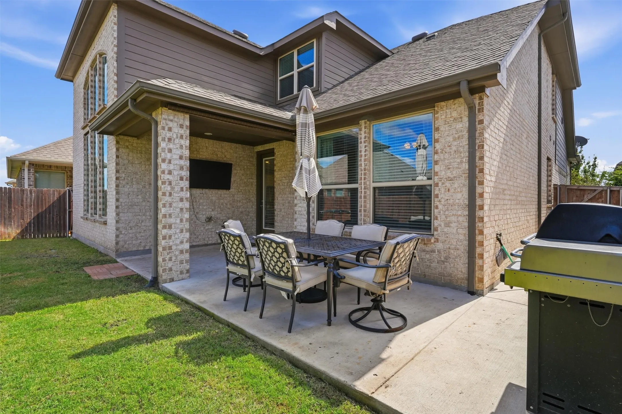 Extended back patio featuring an added concrete pad that broadens your outdoor living space. Designed for seamless indoor-outdoor flow, it offers dedicated zones for shade, sun, outdoor dining, and weekend gatherings in the private backyard.