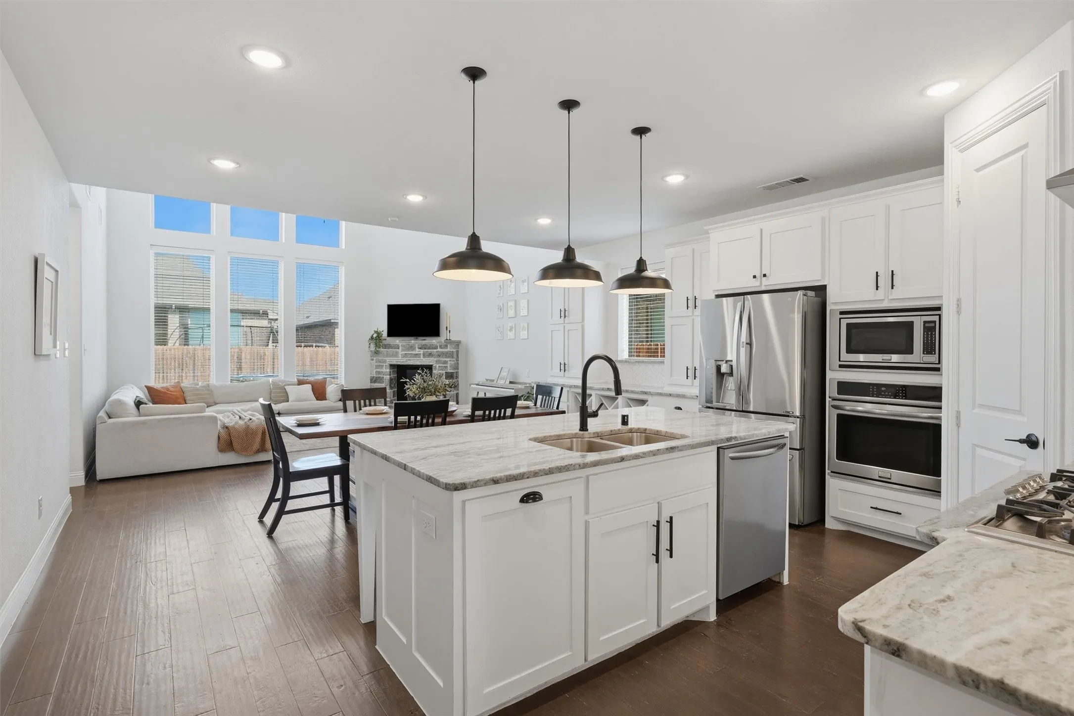 Expansive view highlighting the open-concept floor plan connecting the kitchen, dining, and main living room. Seamless flow and clear sightlines make this space ideal for everyday family living and entertaining guests