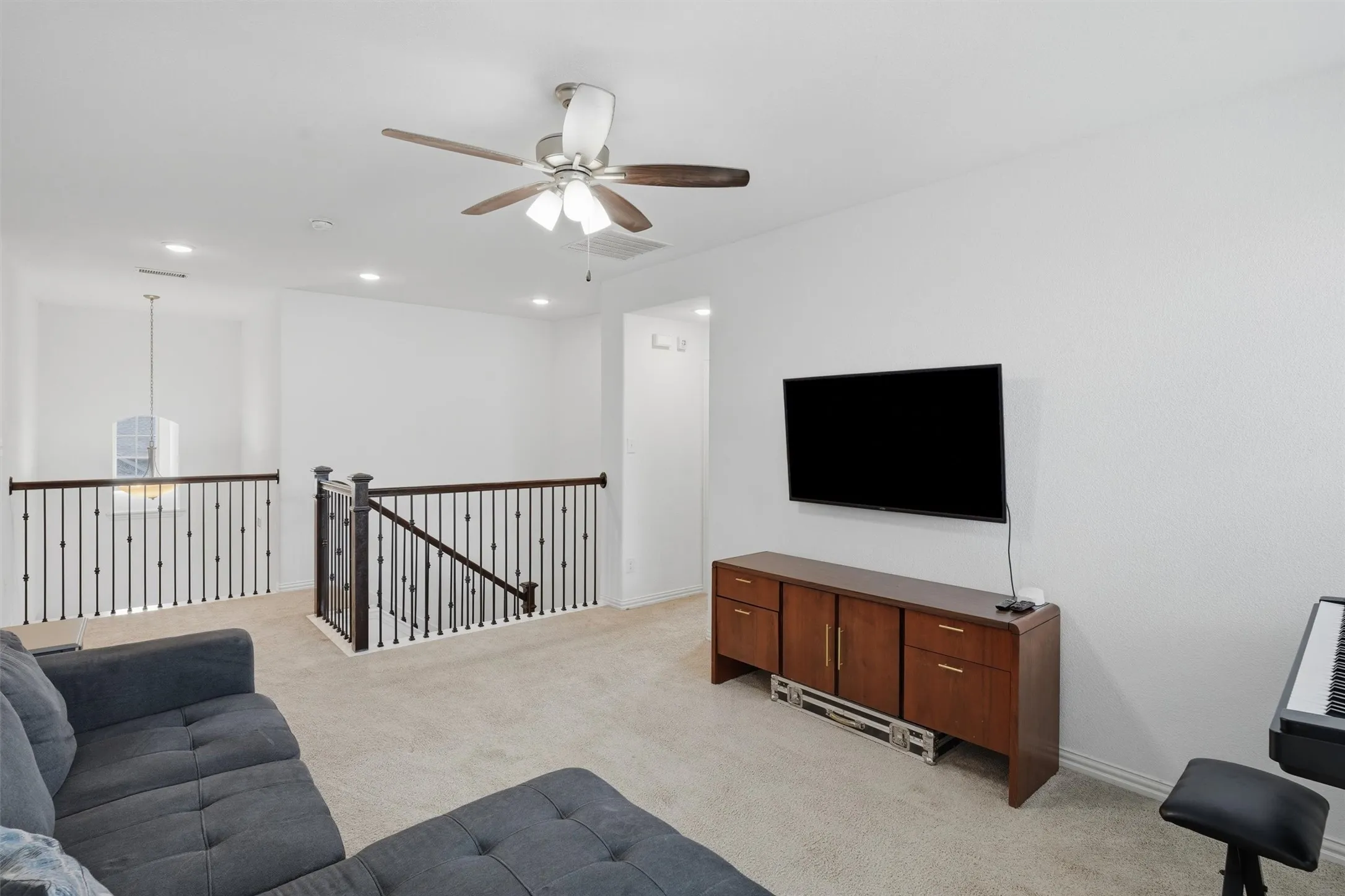 Highlights a flexible layout for a secondary TV lounge, playroom, or study space.