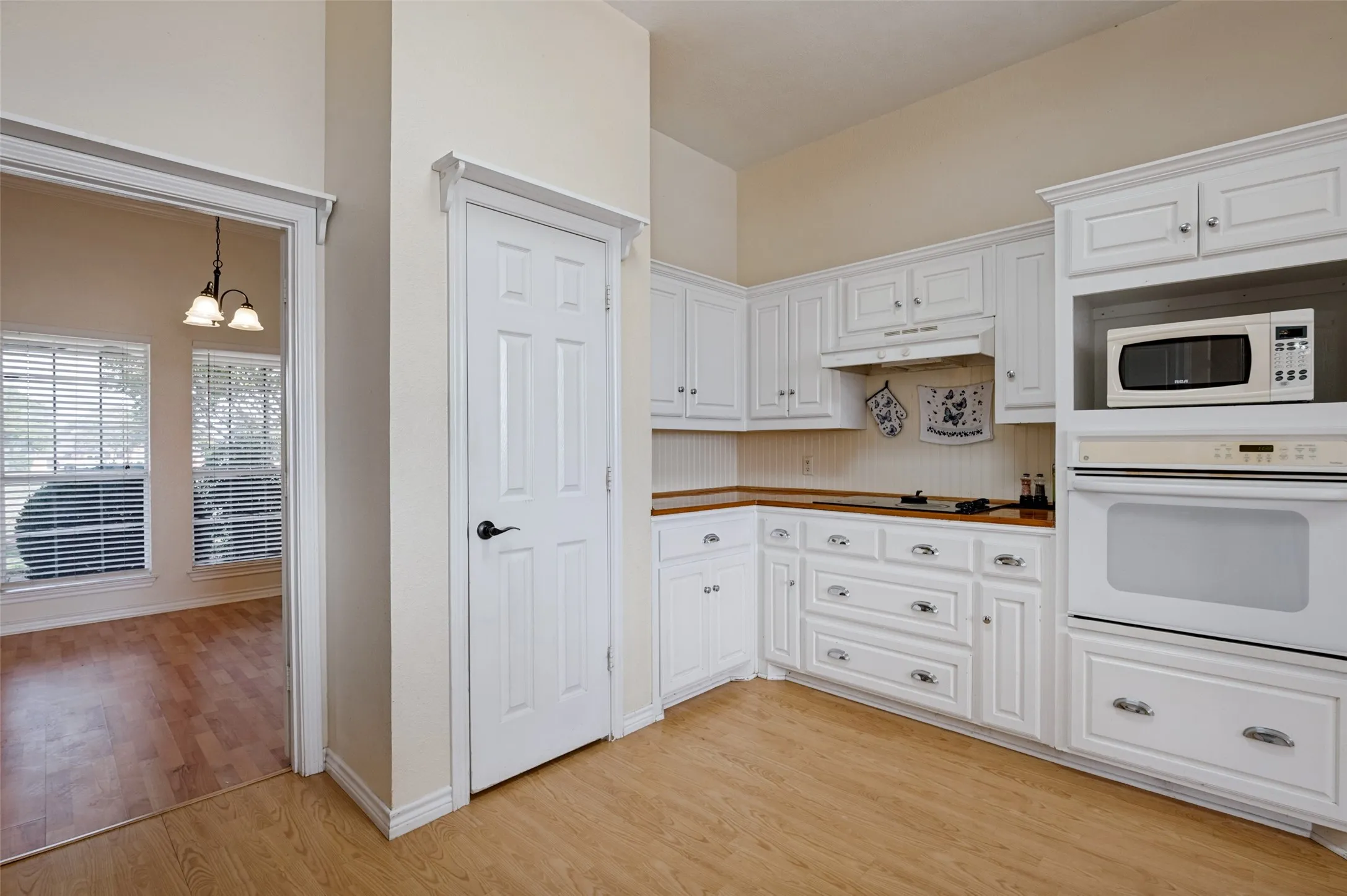 Ample cabinetry provides plenty of storage space, keeping kitchen essentials organized while adding everyday functionality to this inviting space.