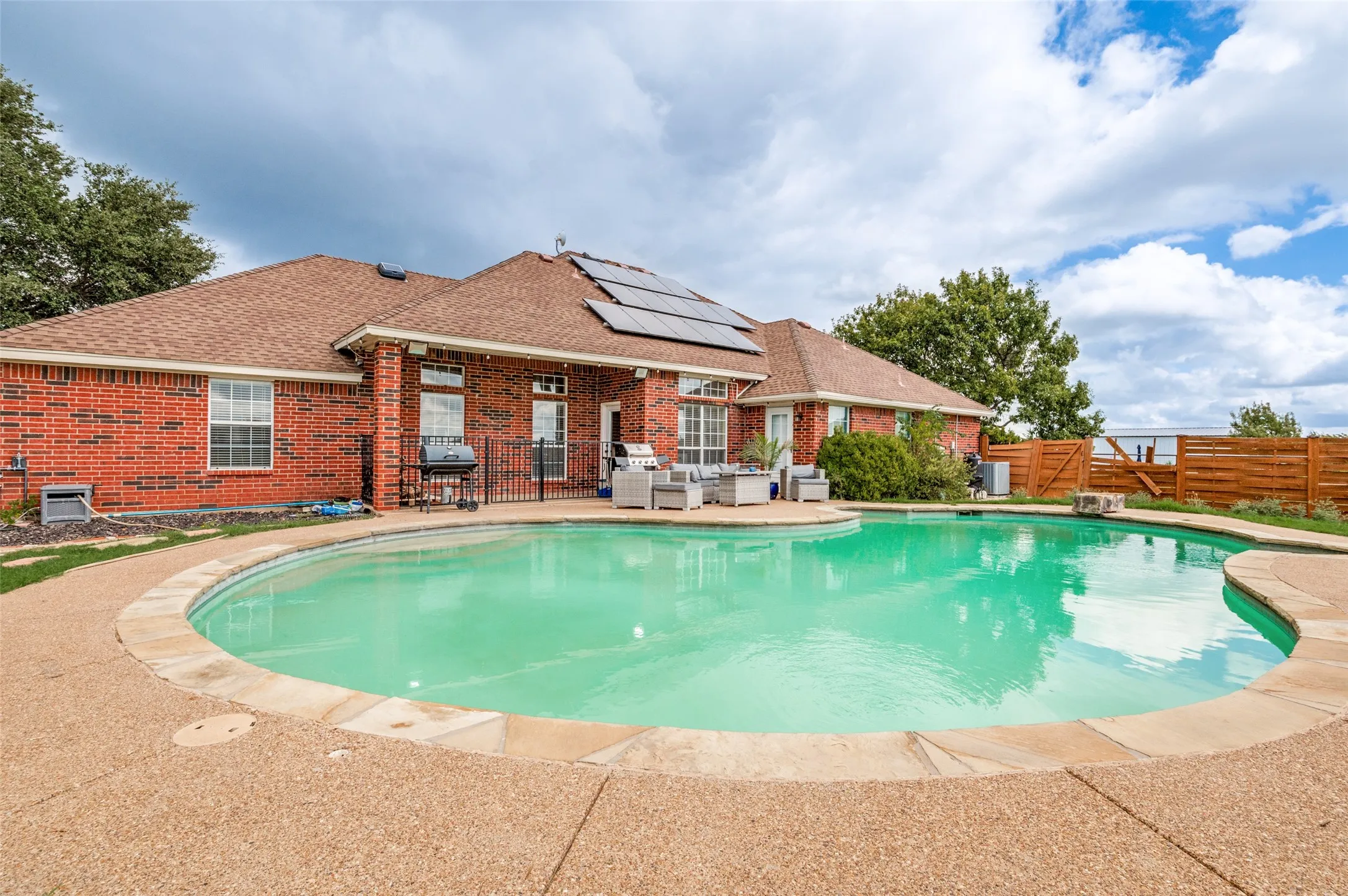 Plenty of poolside deck space offers room for patio furniture, lounging, and entertaining, creating the perfect outdoor retreat to relax and enjoy sunny days.