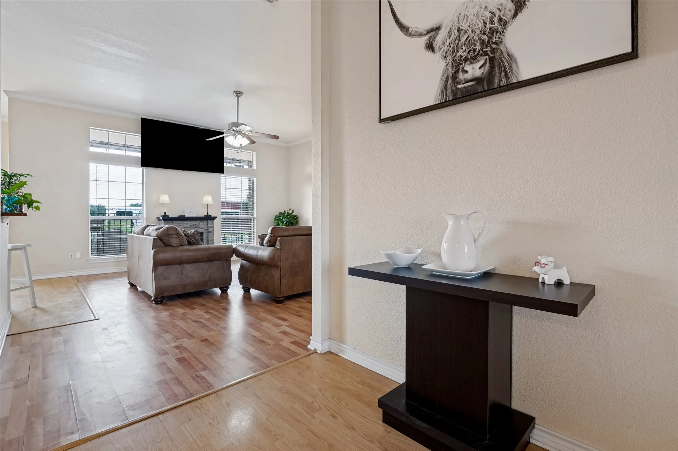 A warm and welcoming entrance offers an immediate view into the living area, with beautiful backyard views that bring the outdoors in and create an open, inviting feel from the moment you step inside.