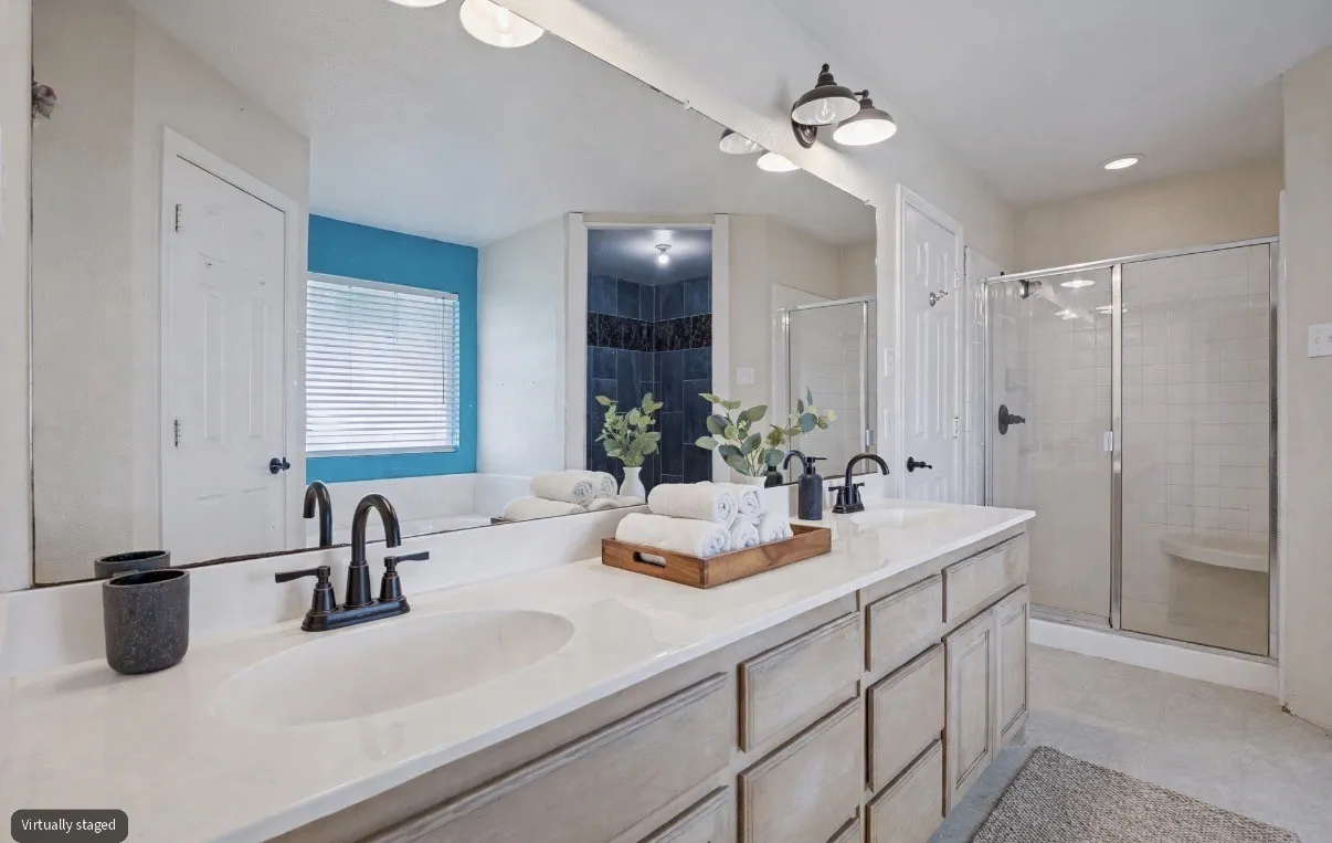 The primary bathroom features dual sinks, providing added convenience and functionality while creating a comfortable space to start and end your day.