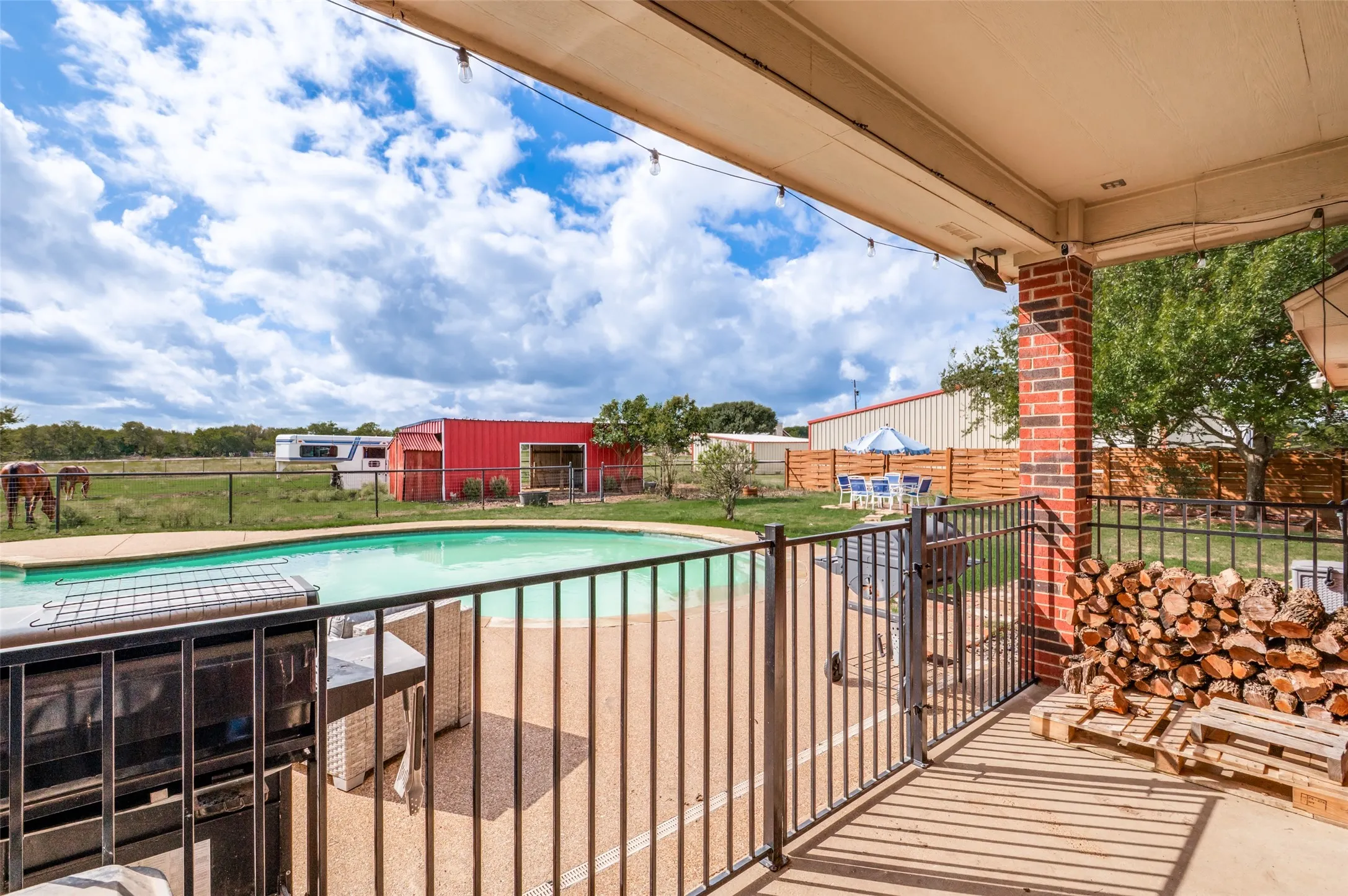 Enjoy relaxing or entertaining on the covered back patio while taking in scenic views of the sparkling pool and expansive two-acre property, the perfect setting to embrace peaceful country living.