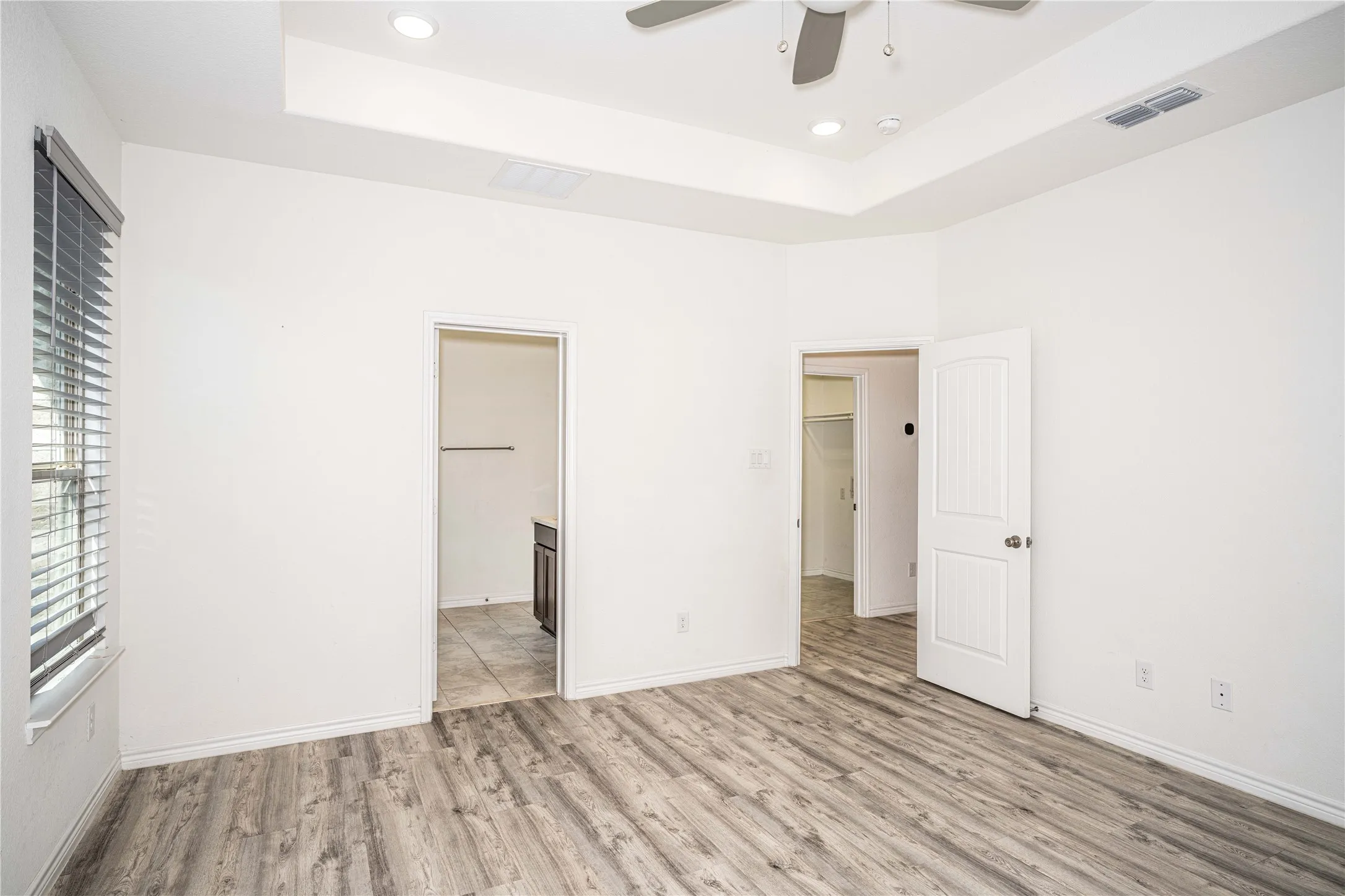 Primary Bedroom with Tray Ceiling & Large Walk-In Closet