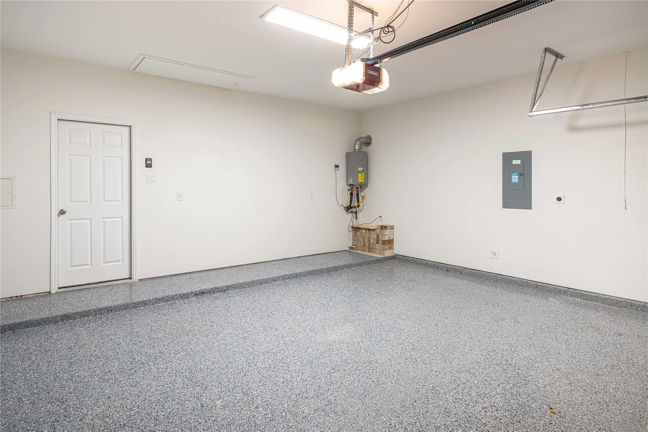 Finished Garage with Epoxy Floor. Home also features a Tankless Water heater.